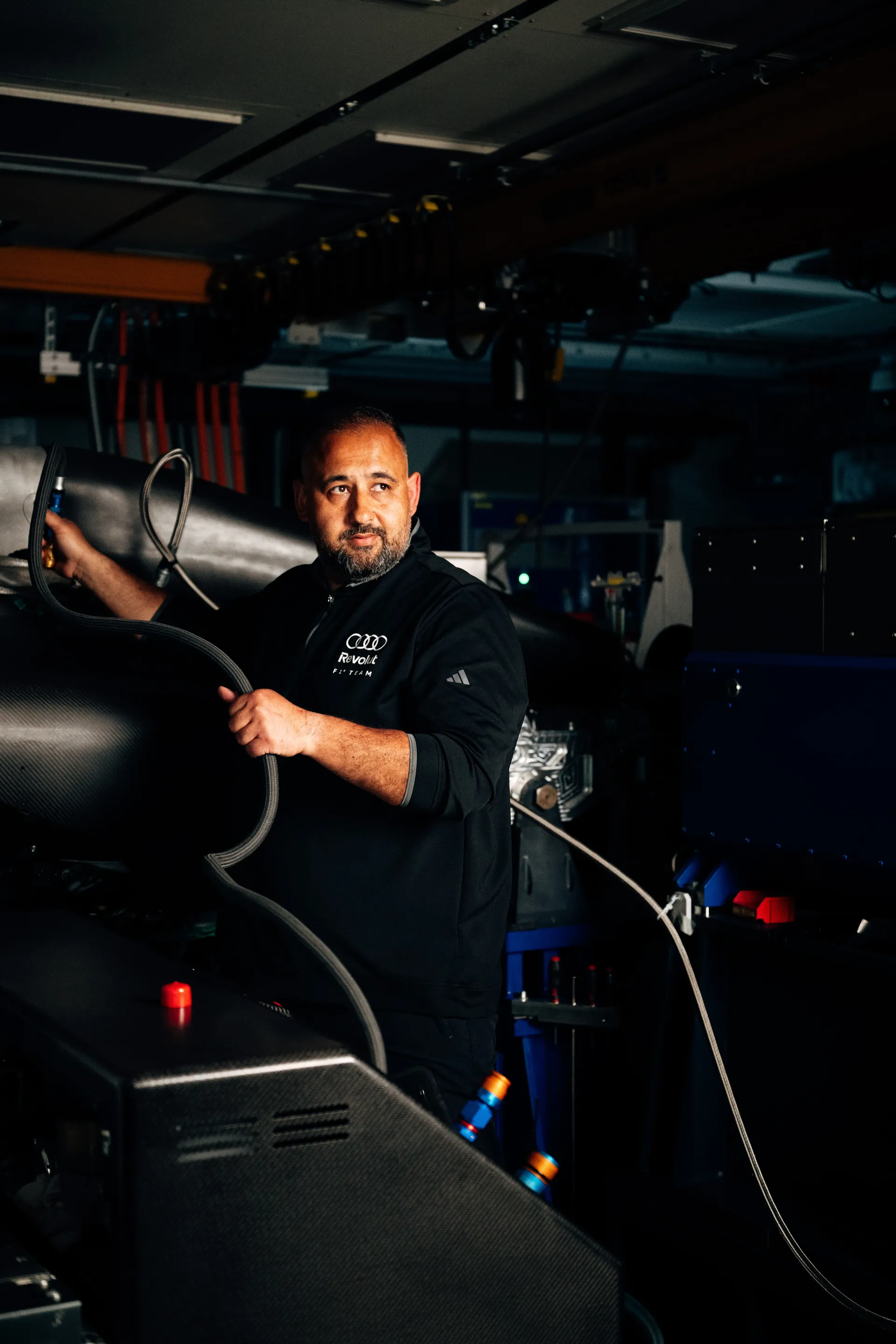 Hakan adjusting equipment on the powertrain test bench, supporting system validation and preparation for on-track performance.
