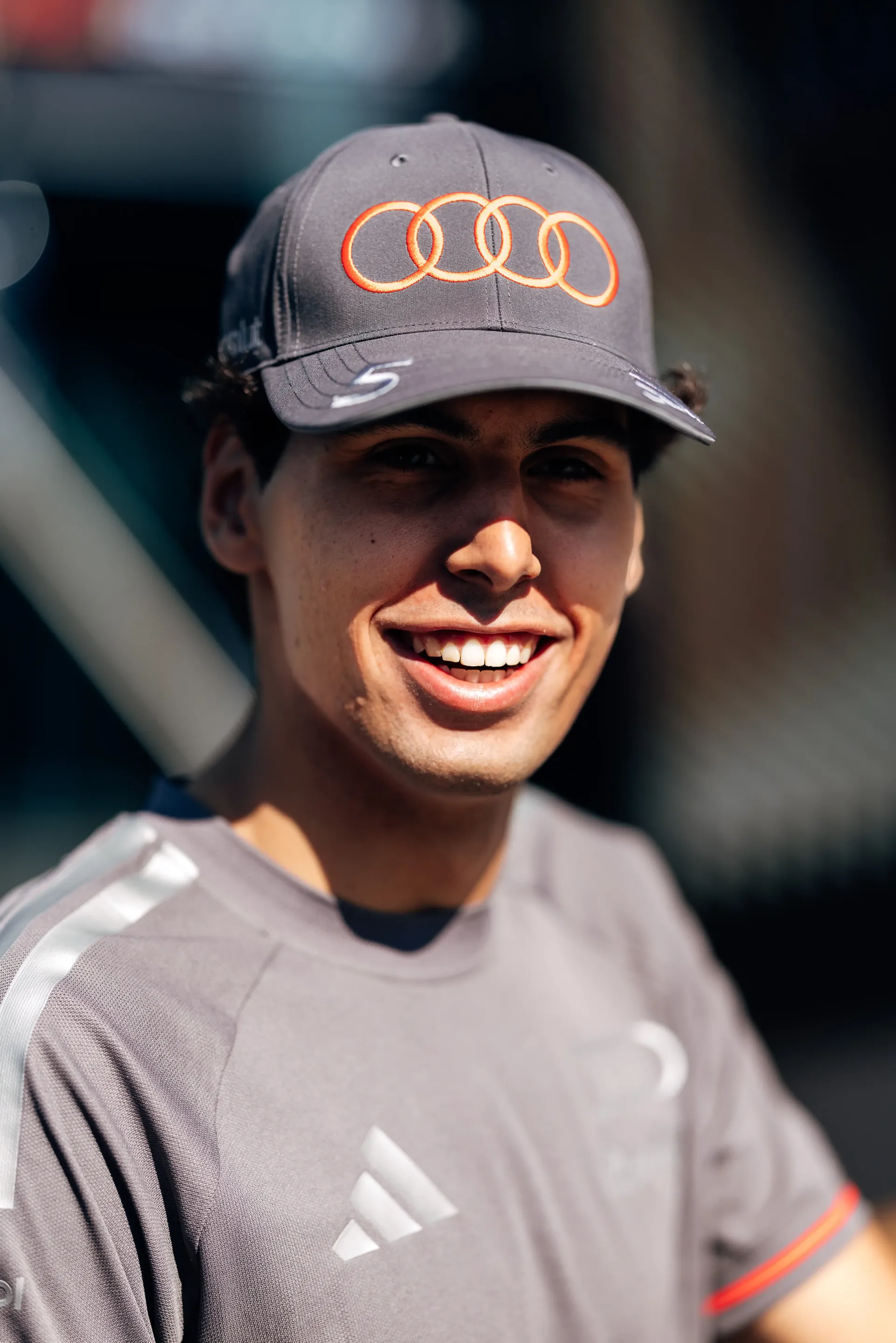 Close-up portrait of Gabriel Bortoleto smiling in the Spielberg paddock ahead of FP3 at the Formula 1® Austrian Grand Prix at the Red Bull Ring, representing Audi Revolut F1® Team.