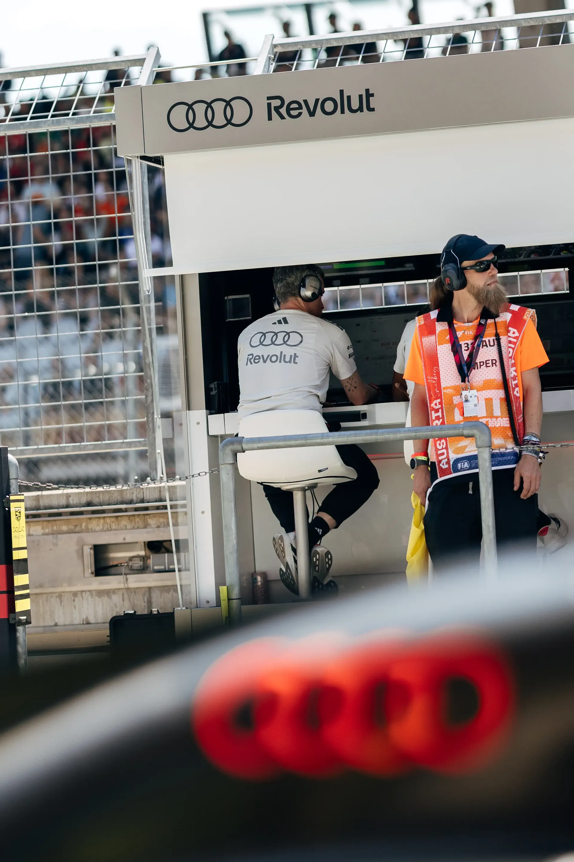 An Audi Revolut F1® Team engineers stands beside the team's pit wall equipment during FP3 at the Austrian Grand Prix in Spielberg, Austria.