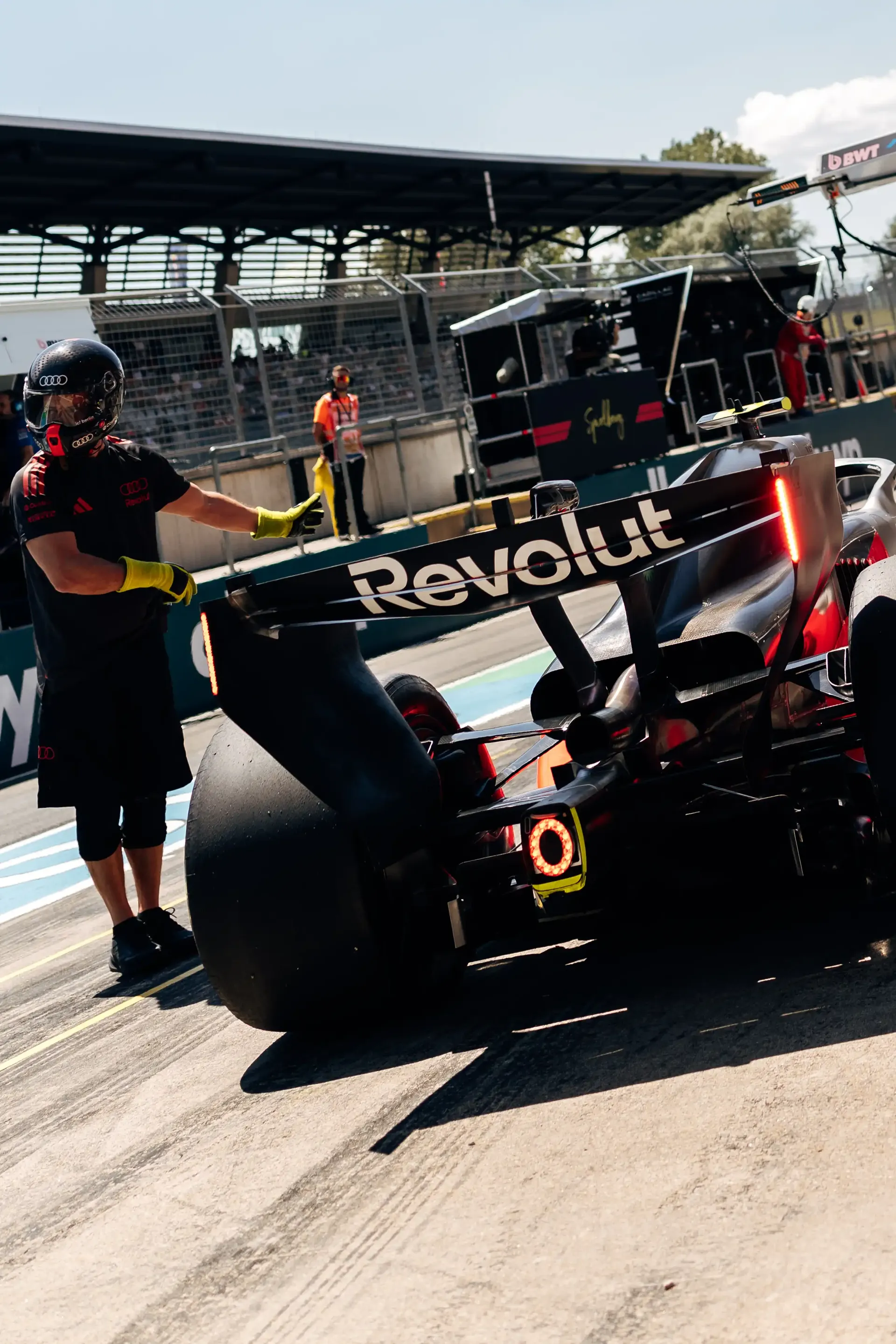 Audi Revolut F1® Team crew push the Audi R26 through the pit lane during FP3 at the Austrian Grand Prix in Spielberg.