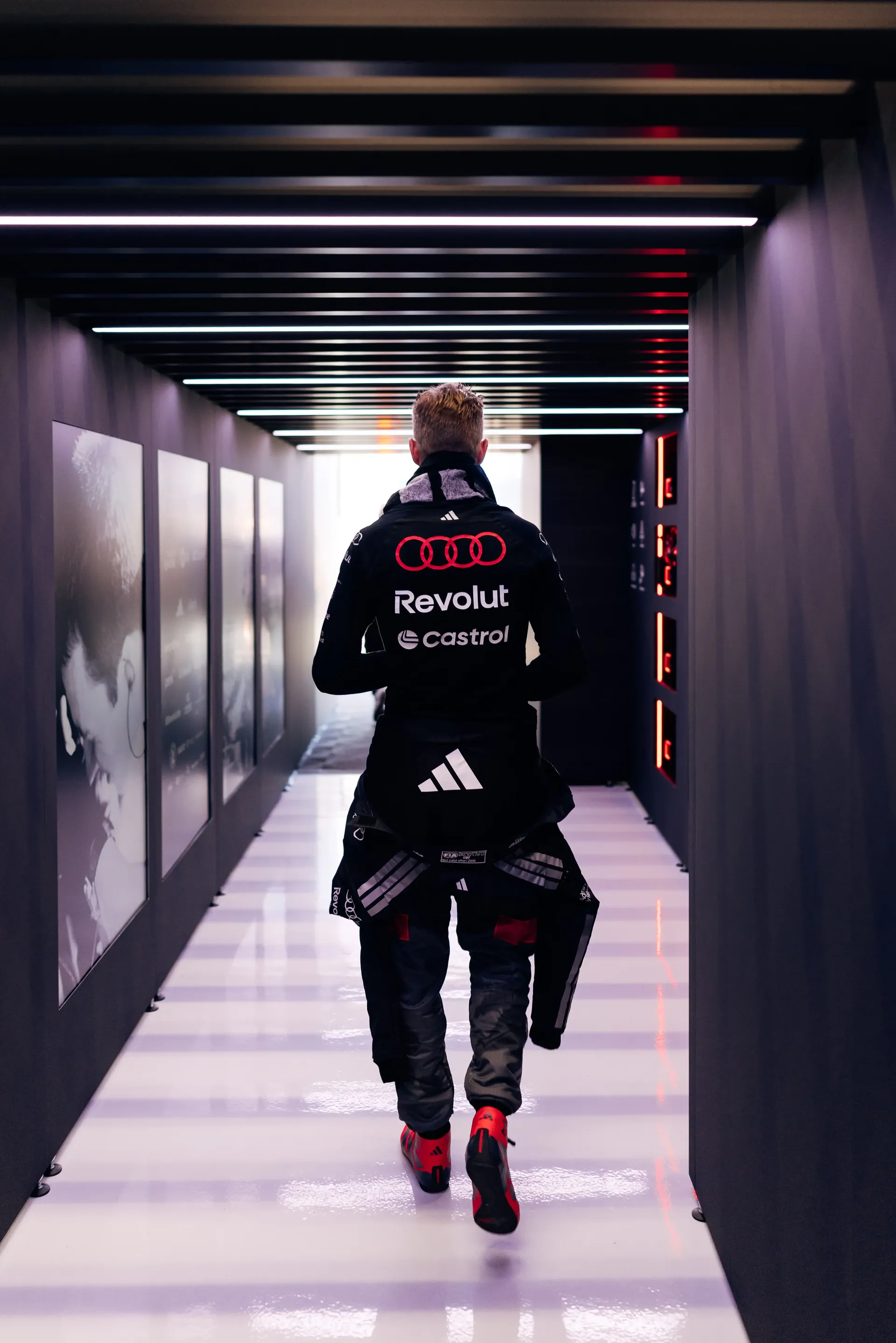 Rear view of an Nico Hulkenberg driver at the Audi Revolut F1® Team walking through the paddock tunnel during FP3 at the Austrian Grand Prix in Spielberg.