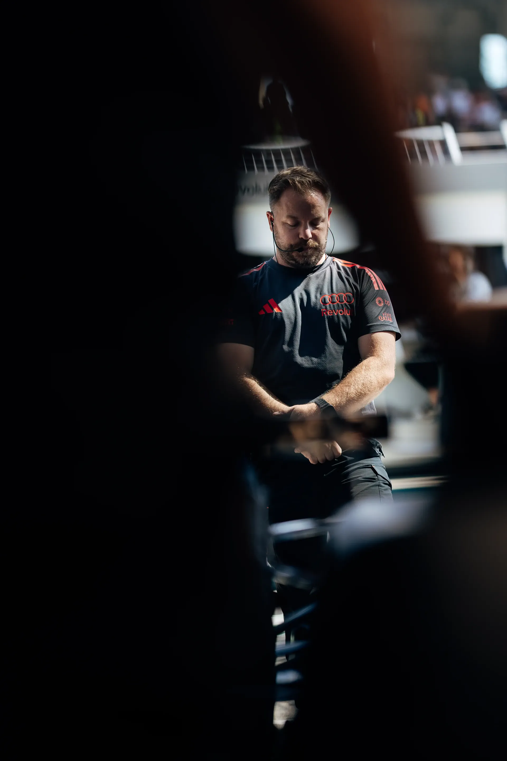 Audi Revolut F1® Team mechanic tanding in the garage during Qualifying at the Austrian Grand Prix in Spielberg.