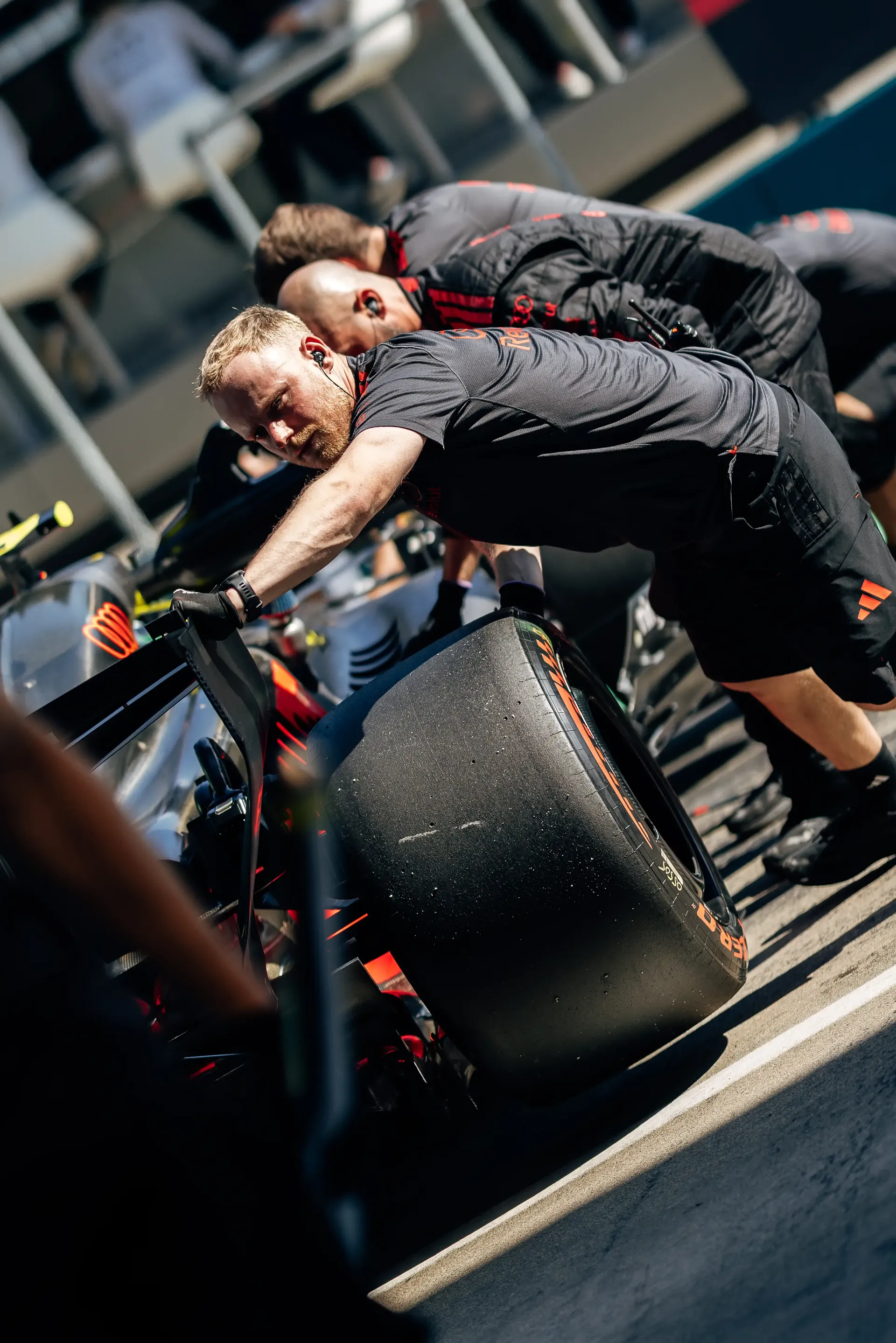 Audi Revolut F1® Team mechanics push the Audi R26 through the pit lane during Qualifying at the Austrian Grand Prix in Spielberg.