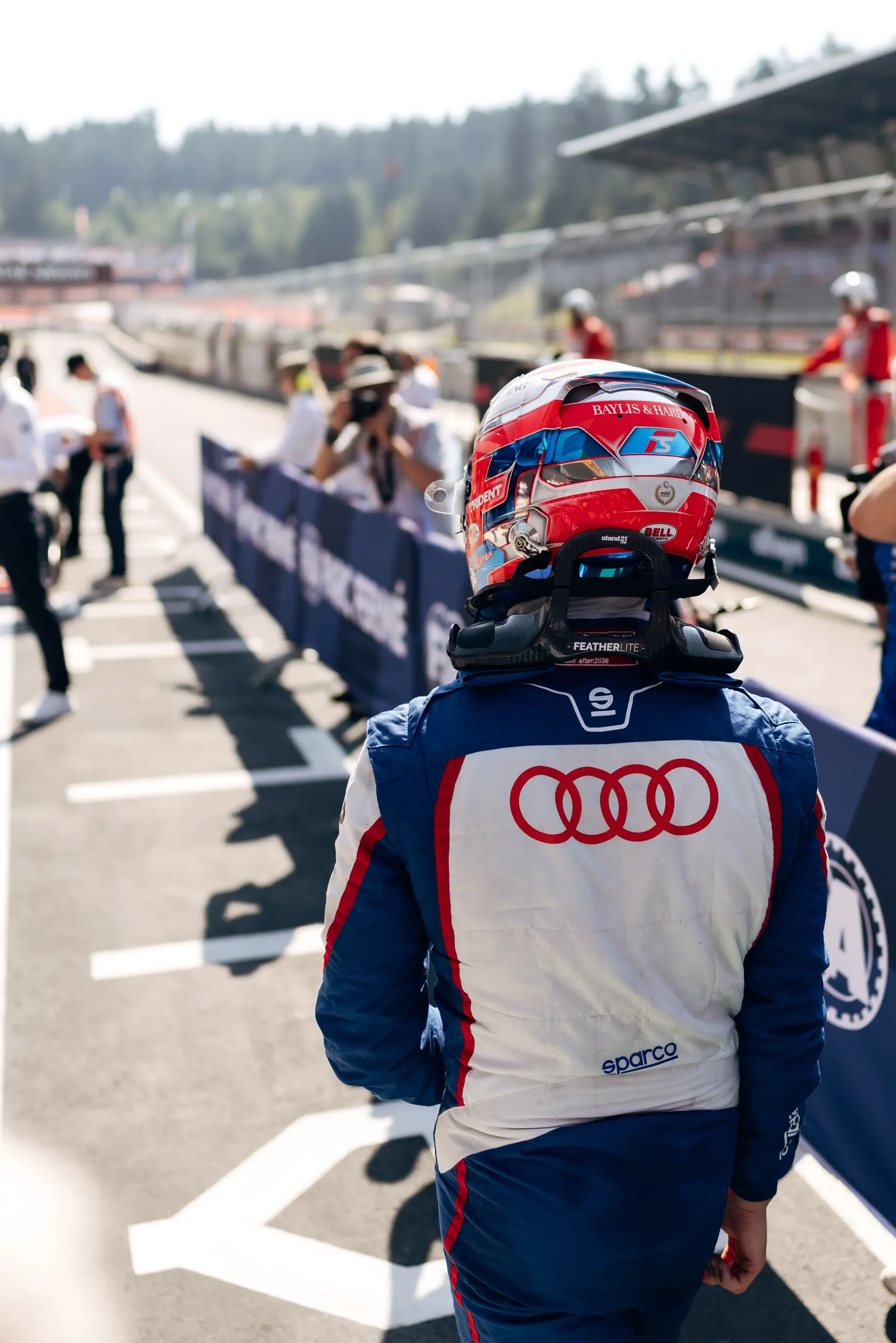 Rear view of Freddie Slater walking through parc fermé after the FIA Formula 3 Feature Race at the Austrian Grand Prix in Spielberg.