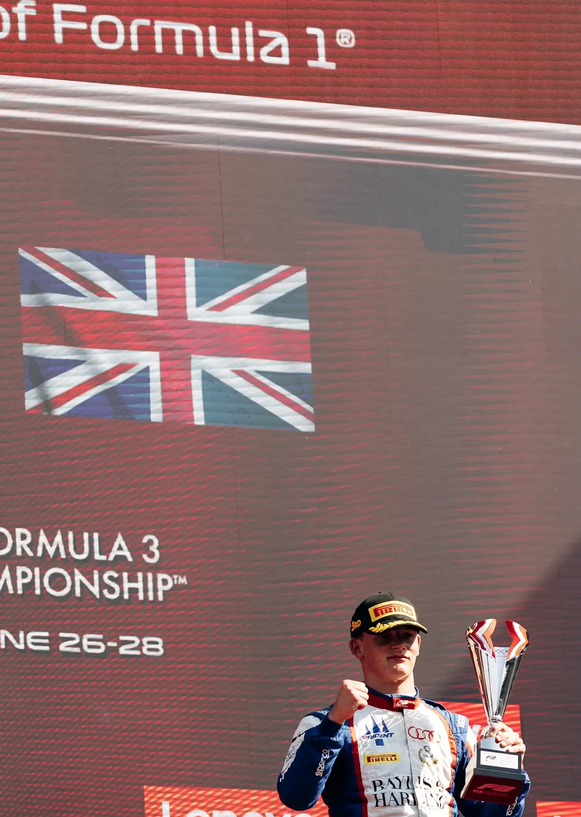 Freddie Slater celebrates his third-place finish on the FIA Formula 3 podium after the Austrian Grand Prix Feature Race in Spielberg.