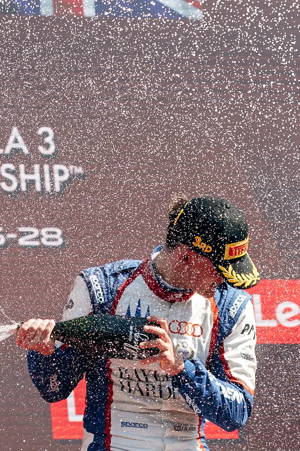 Freddie Slater sprays champagne during the FIA Formula 3 podium celebrations after the Austrian Grand Prix Feature Race in Spielberg.