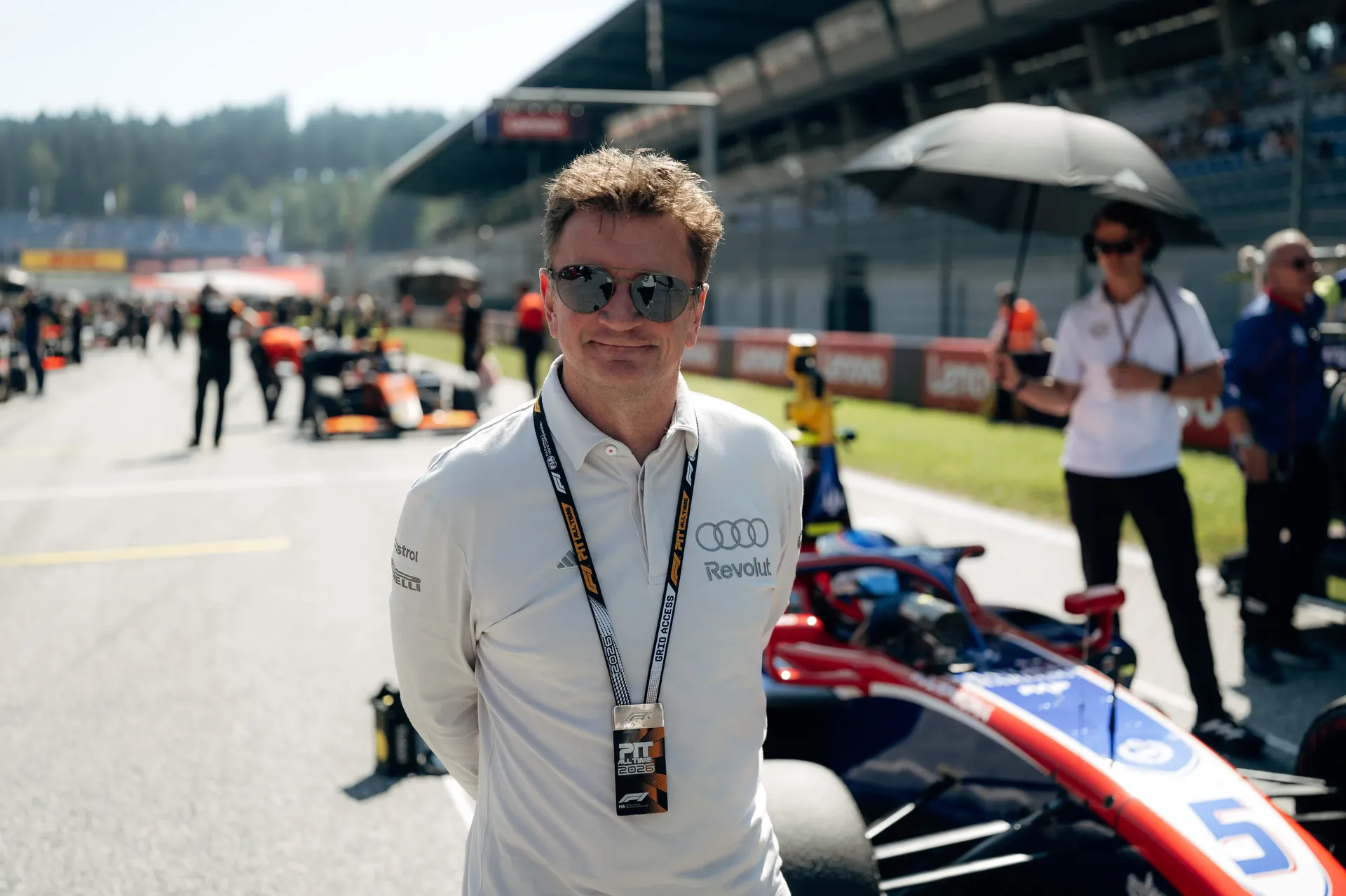 Allan McNish, Racing Director of the Audi Revolut F1® Team, stands in the Spielberg paddock on race day.