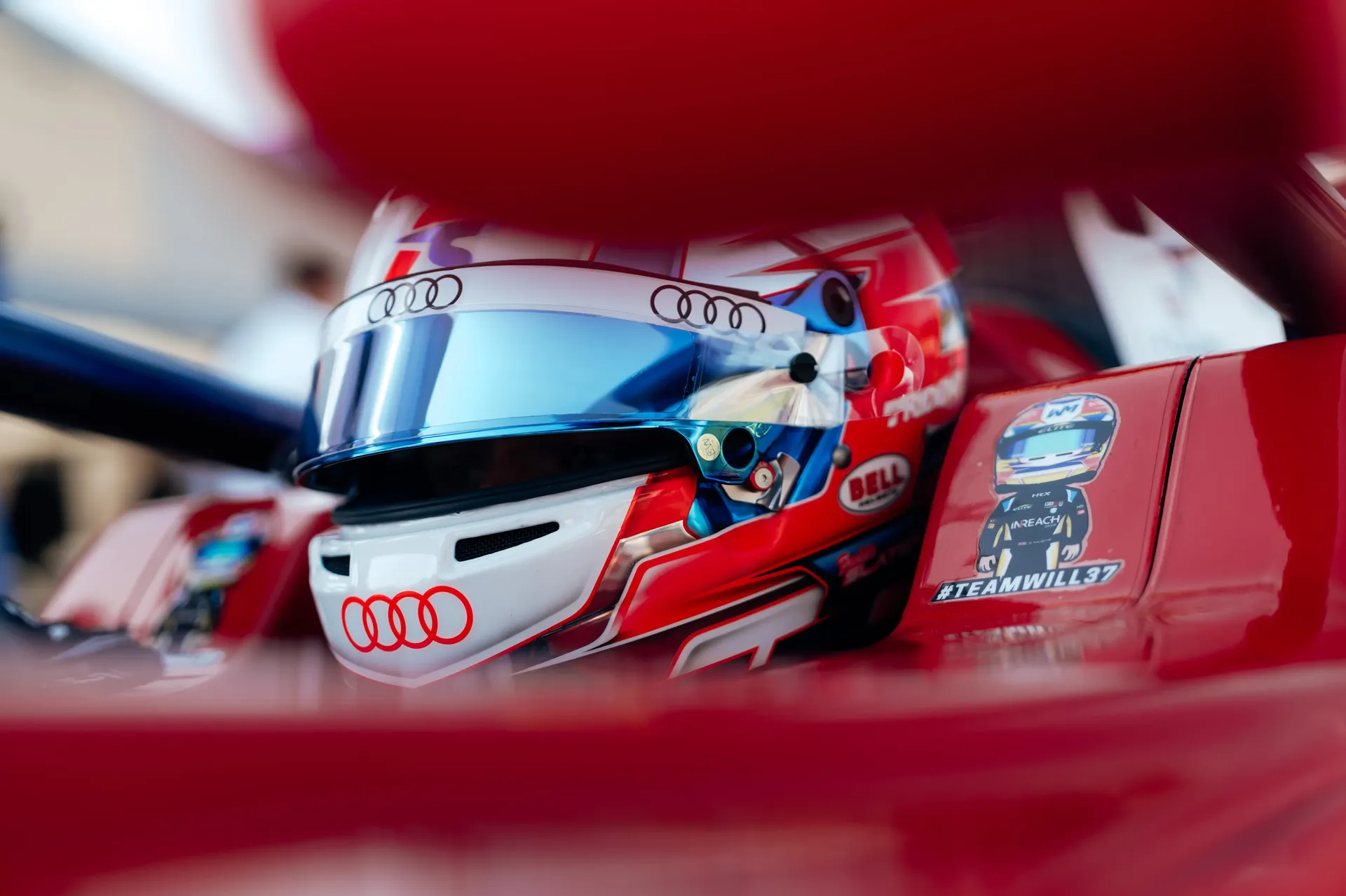 Creative close-up of Freddie Slater's helmet framed through the bodywork of his FIA Formula 3 car.