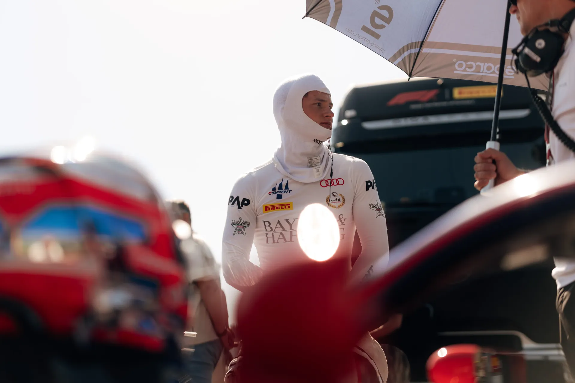 Freddie Slater stands in the Spielberg paddock in his race suit before the FIA Formula 3 race.