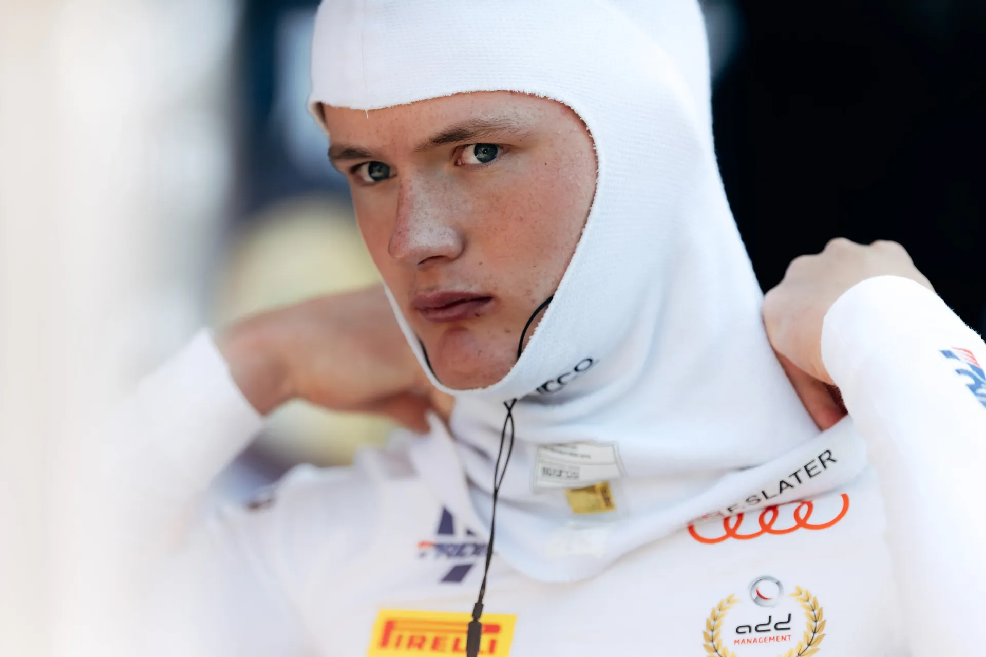 Portrait of Freddie Slater wearing a balaclava as he prepares for the FIA Formula 3 race at Spielberg.