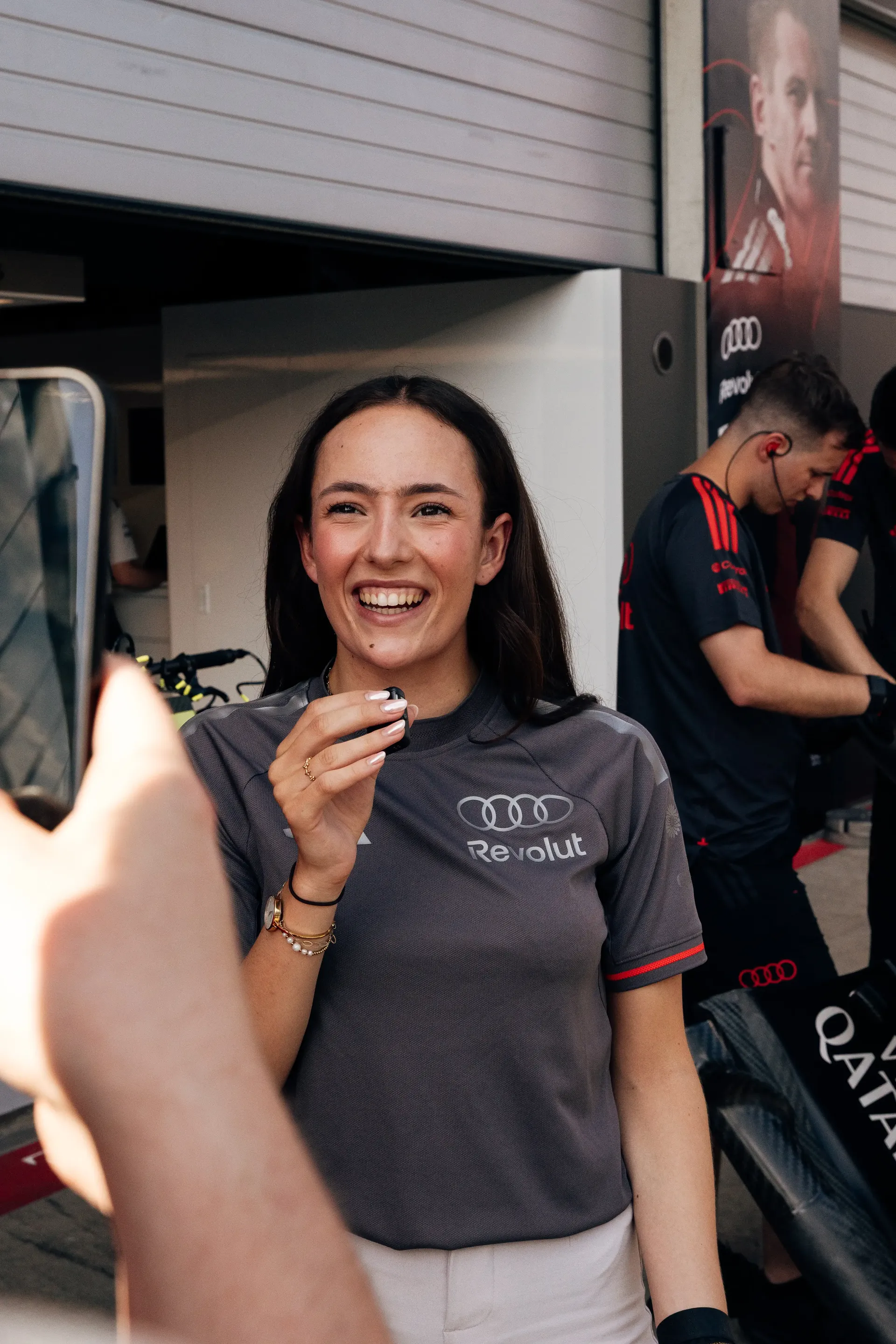 Emma Felbermayr, Audi Driver Development Programme and Academy F1® driver, smiles in the Audi Revolut F1® Team garage during the Austrian Grand Prix weekend at Spielberg.
