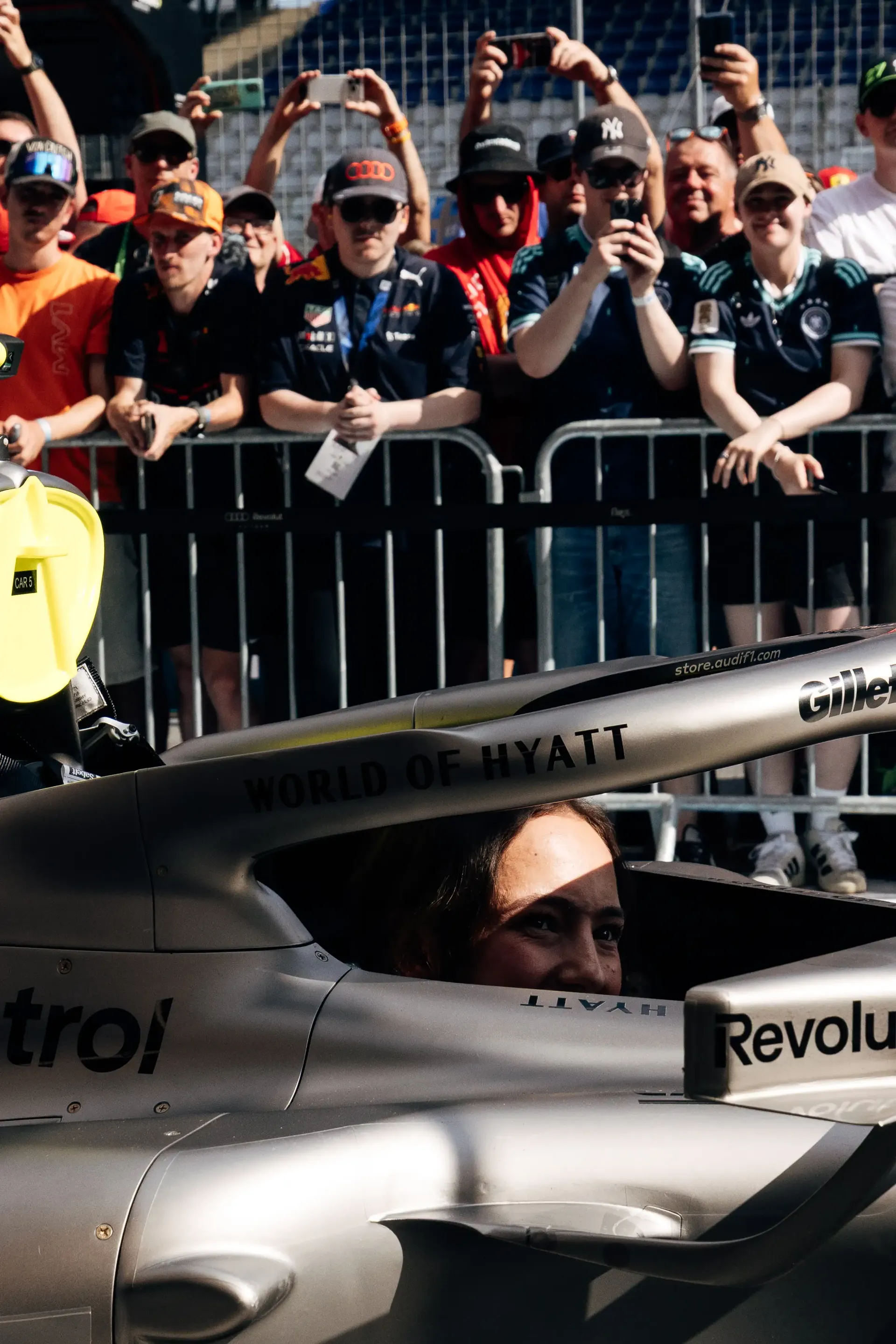 Emma Felbermayr, Audi Driver Development Programme and Academy F1® driver, sits in the Audi R26 in the pit lane as fans gather behind the barriers at Spielberg.