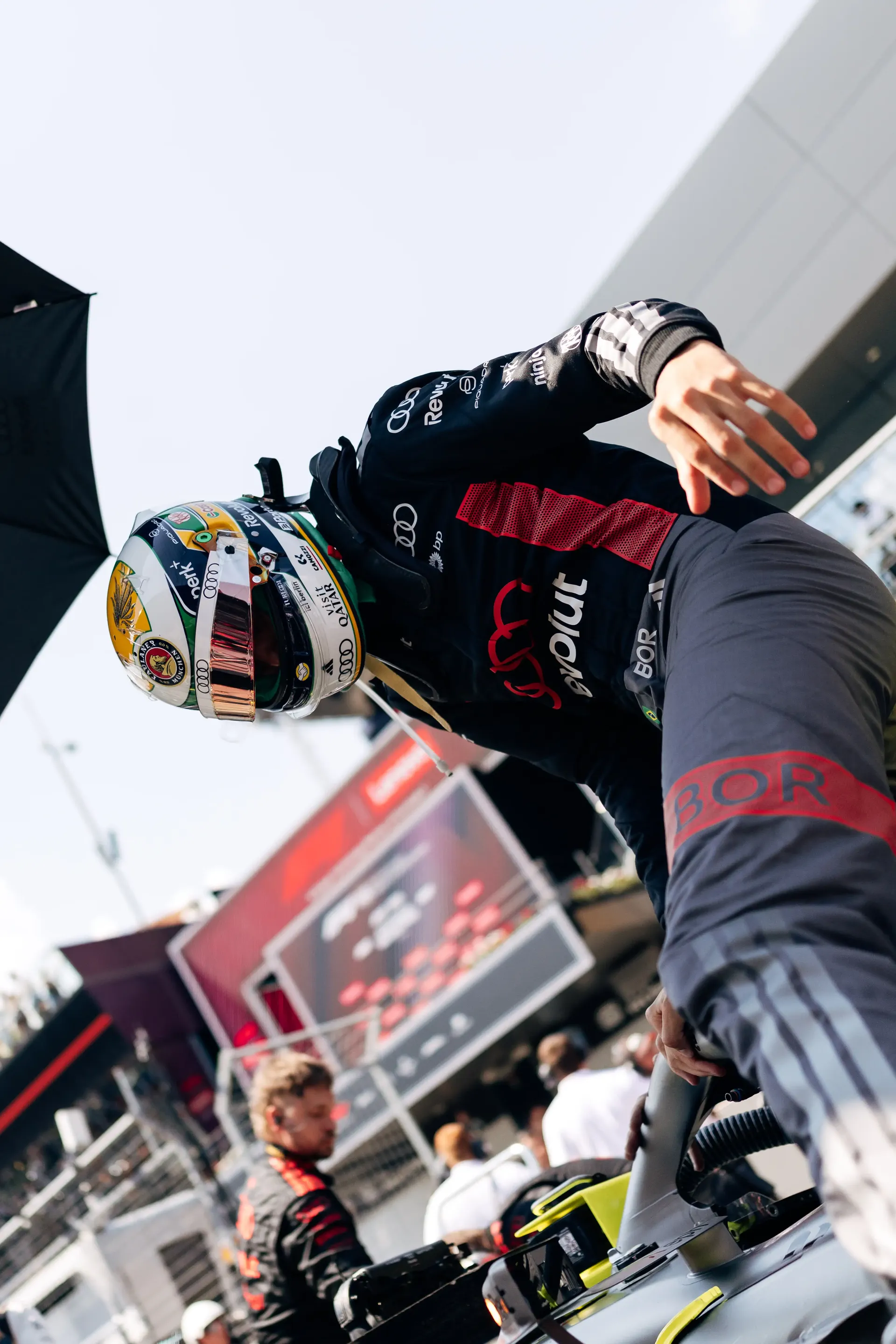 Gabriel Bortoleto climbs from the cockpit of the Audi Revolut F1® Team R26 before the race at the Formula 1® Austrian Grand Prix at the Red Bull Ring.
