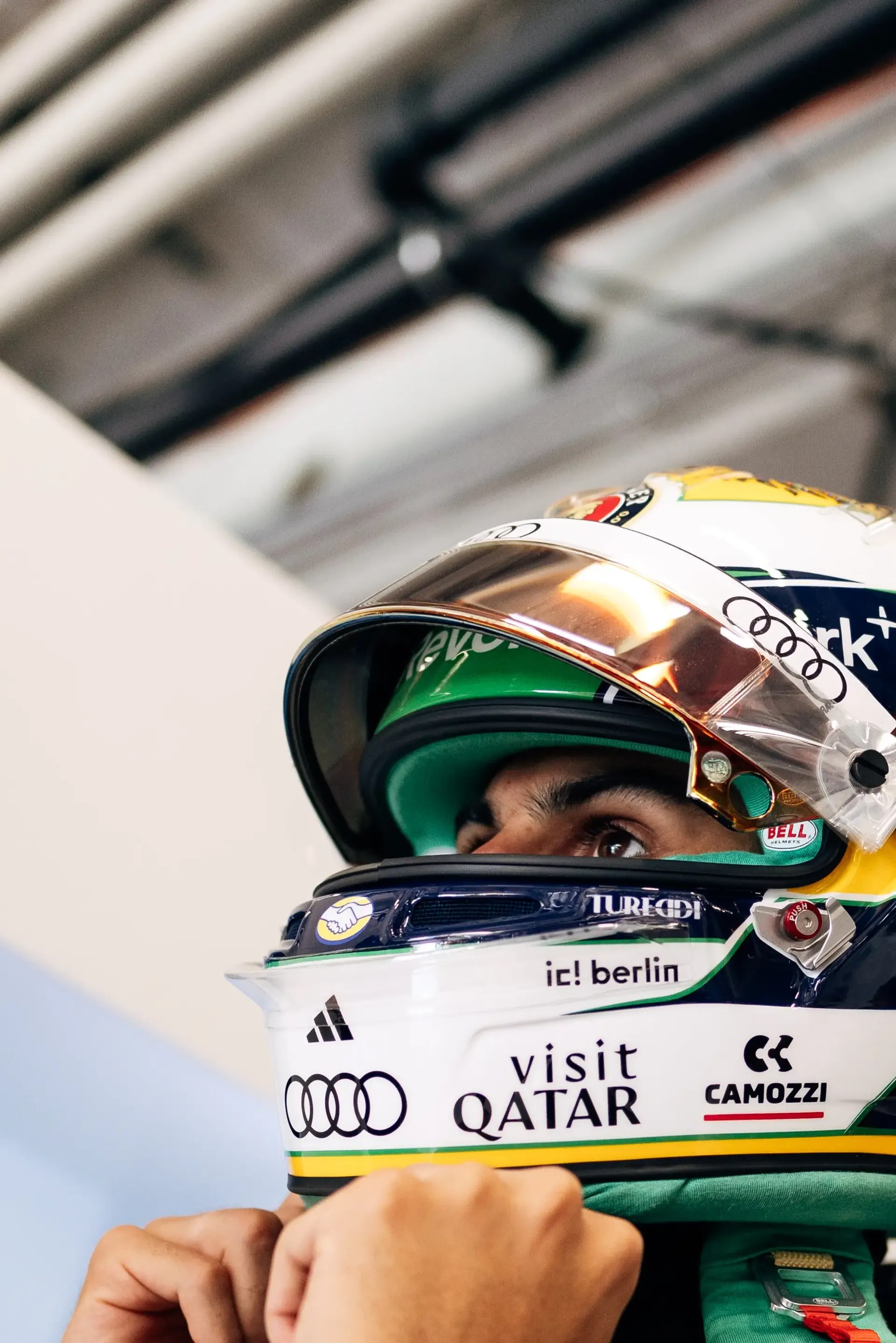Close-up portrait of an Audi Revolut F1® Team driver Gabriel Bortoleto wearing a helmet inside the garage before the race.