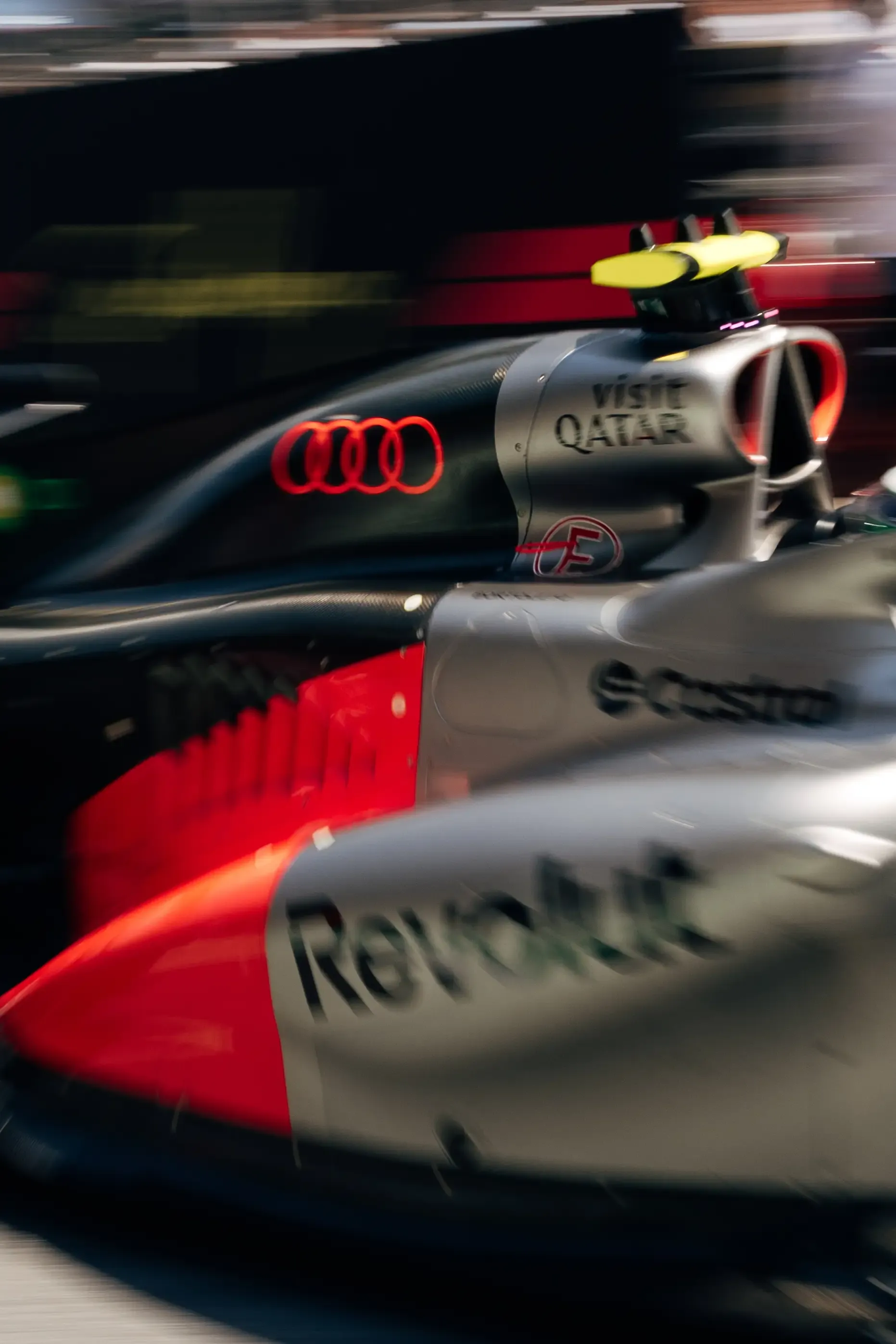 Creative motion-blur detail of the Audi R26 highlighting the sidepod and rear wing.