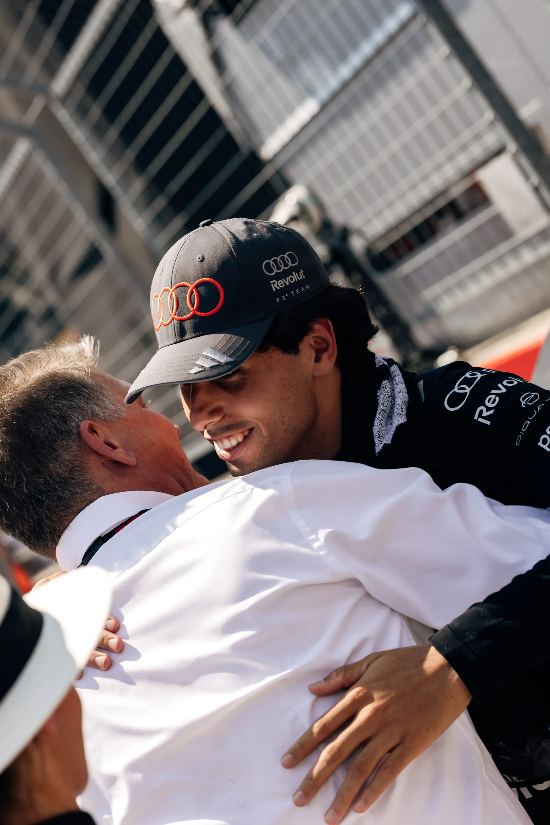 Gabriel Bortoleto driver at the Audi Revolut F1® Team embrace in celebration in the paddock after the race.