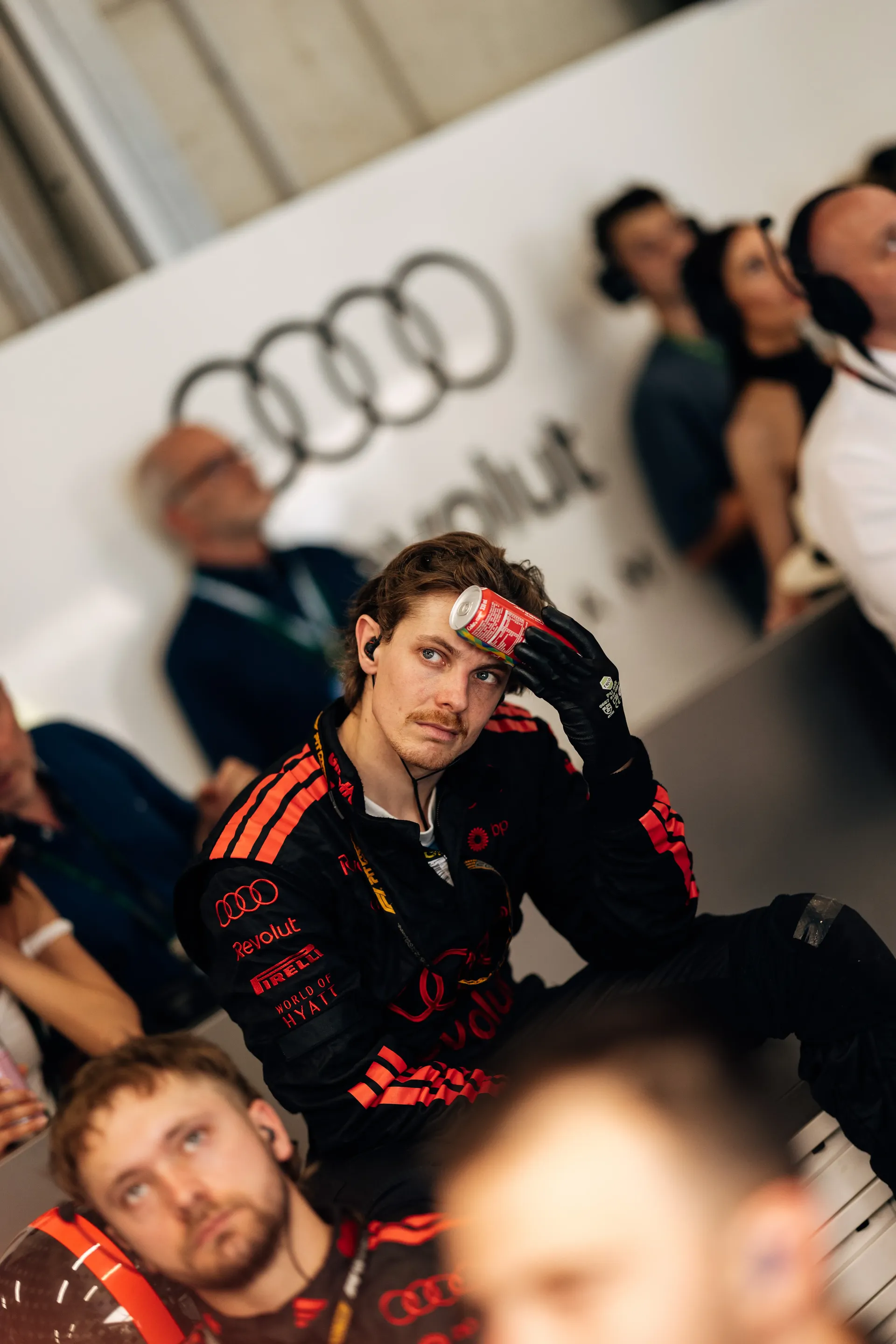 Audi Revolut F1® Team mechanics watch the race from inside the team garage.