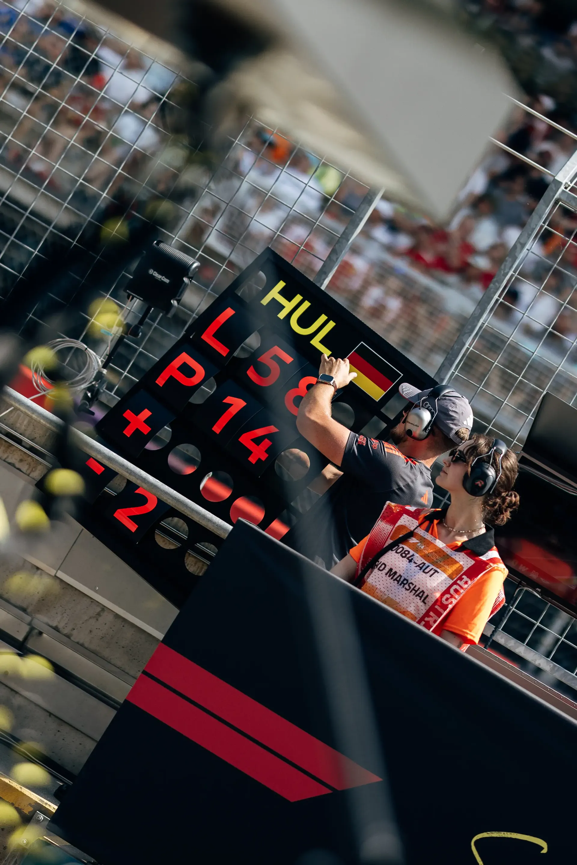 Motion-blurred view of a timing screen and the Audi R26 capturing the intensity of race day at Spielberg.