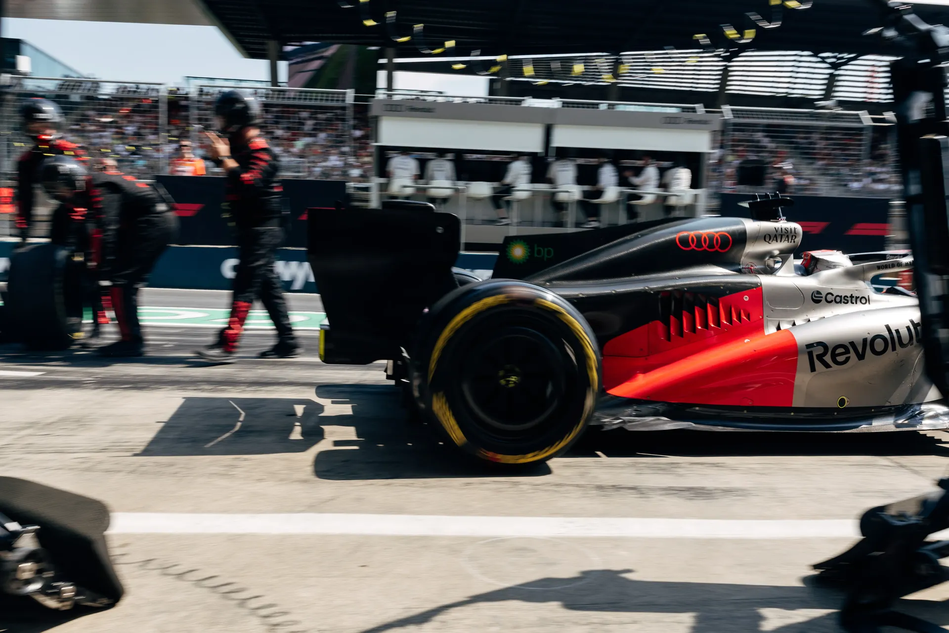 Side view of the Audi R26 in the pit lane as mechanics prepare for the race.