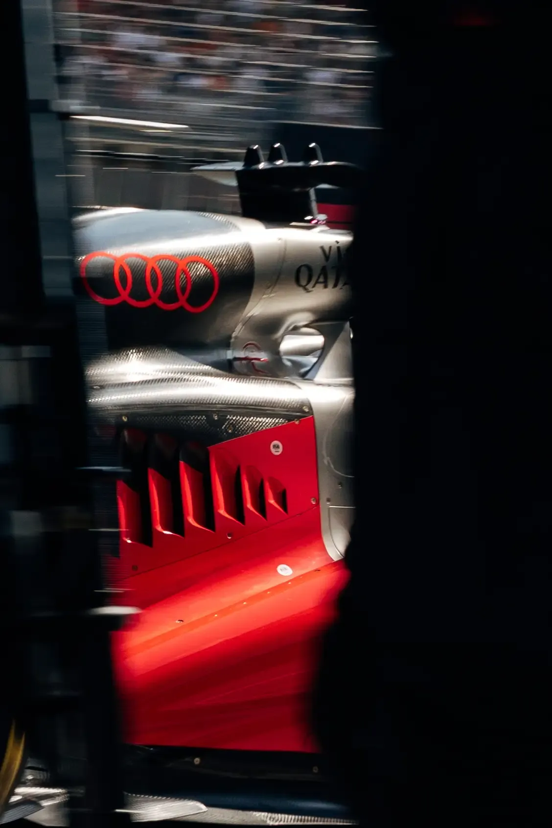 Artistic motion-blur close-up of the Audi R26 featuring the rear bodywork and branding.