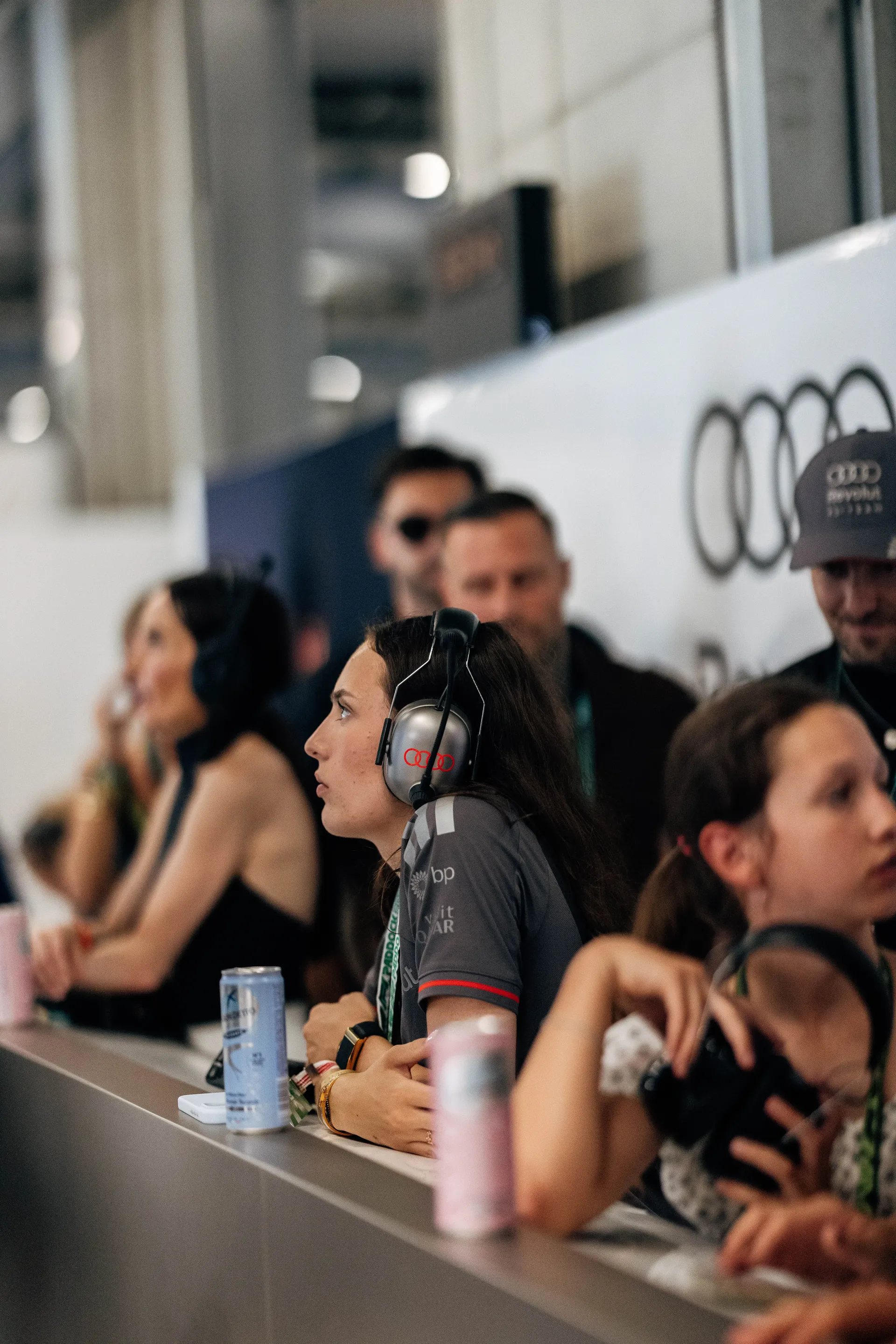 Audi Revolut F1® Team guests and Emma Felbermayr watch the race from the garage viewing area.