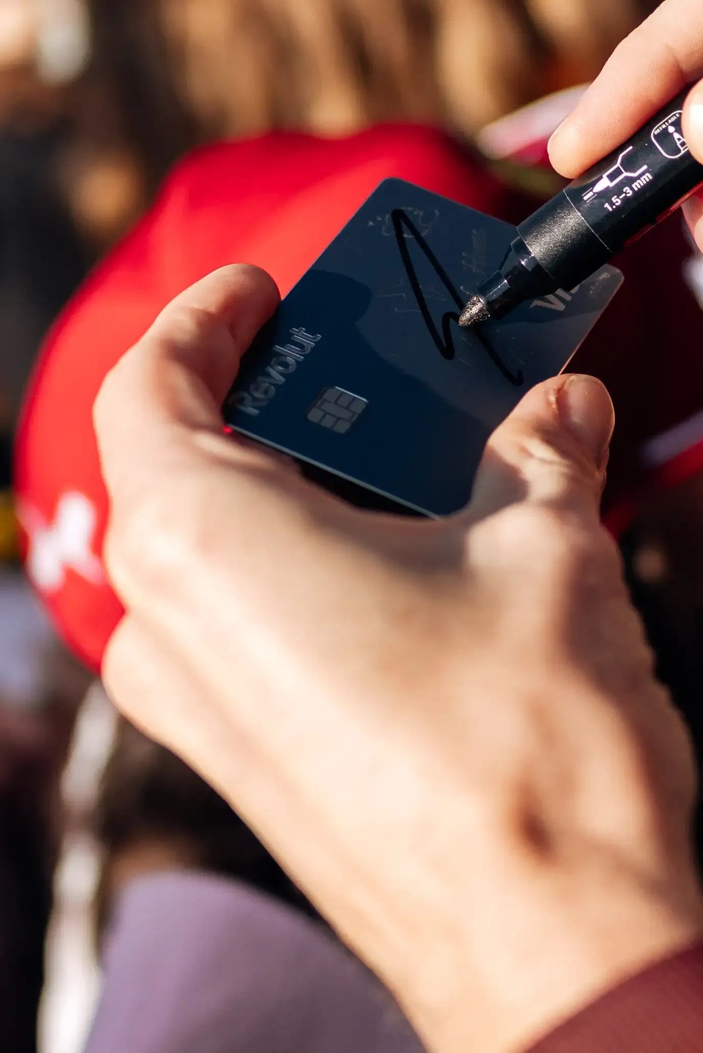 Close-up of Nico Hulkenberg signing an autograph for a fan before the Formula 1® Austrian Grand Prix in Spielberg before the race.