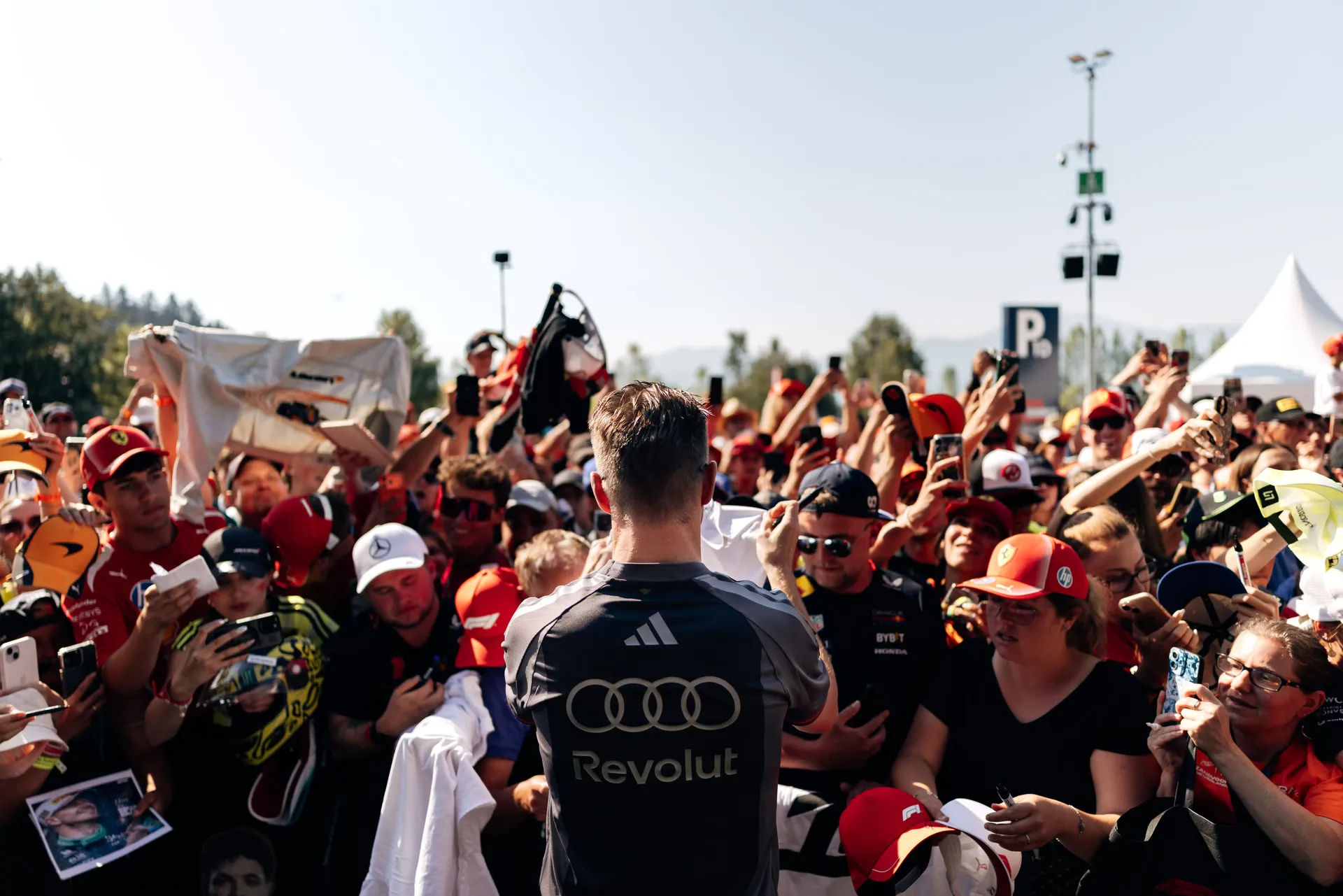 Rear view of Nico Hulkenberg greeting fans during the traditional Austrian welcome before the Formula 1® Austrian Grand Prix in Spielberg before the race.