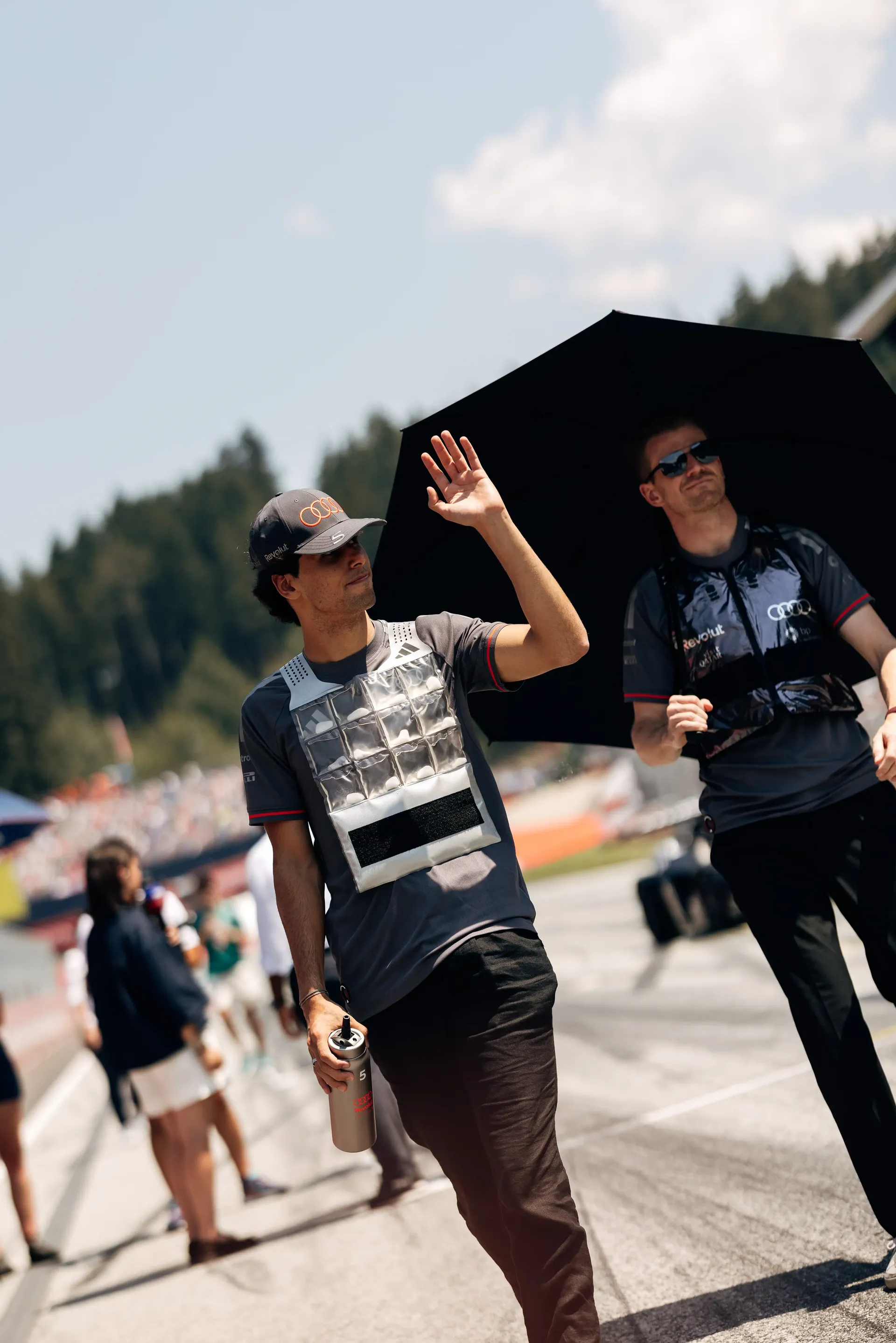 Gabriel Bortoleto waves to fans in the paddock ahead of the Formula 1 Drivers' Parade before the Austrian Grand Prix in Spielberg.