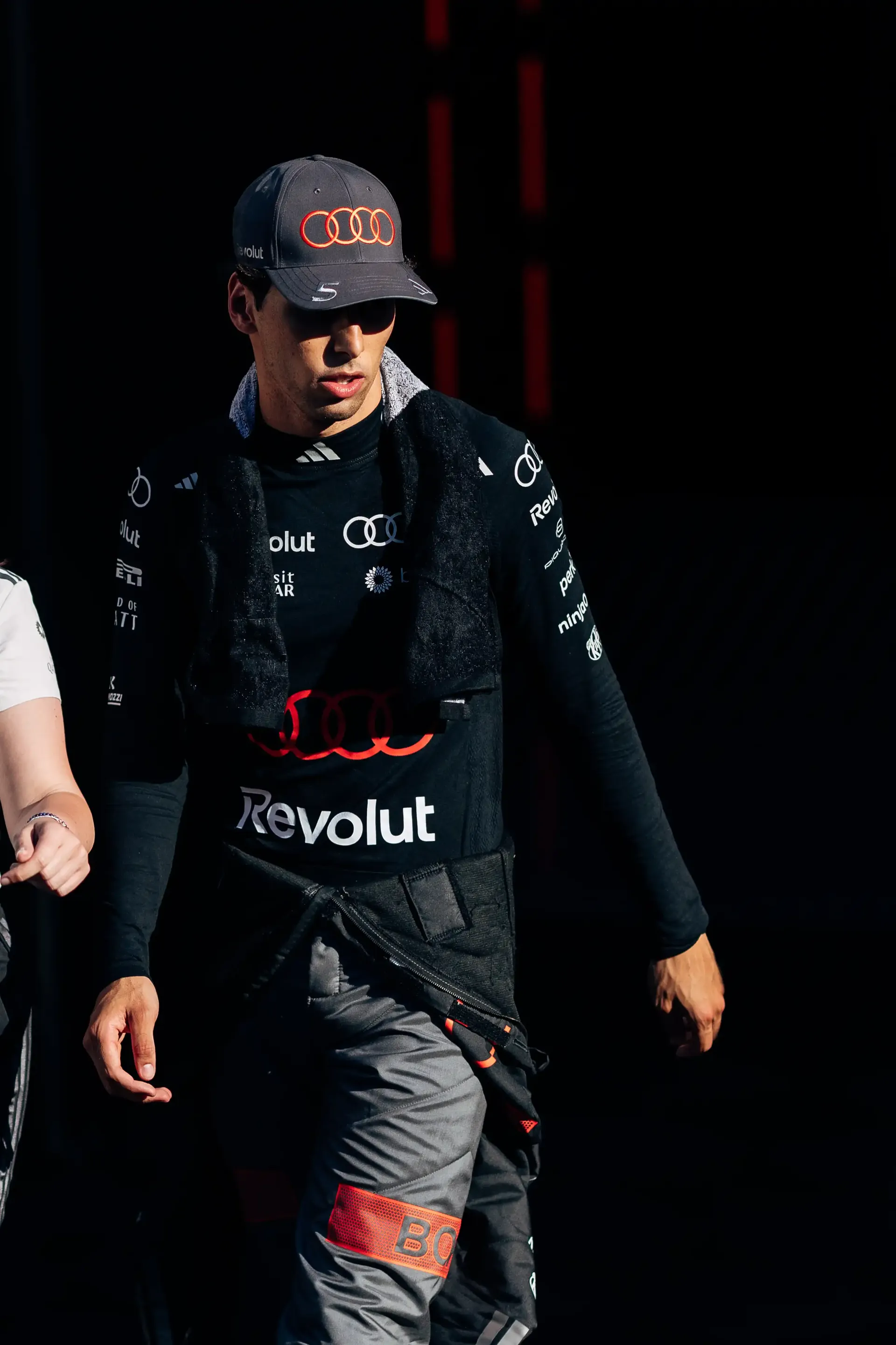 Audi Revolut F1® Team driver Gabriel Bortoleto walking through the paddock after a run during FP2 at Spielberg, Austria.