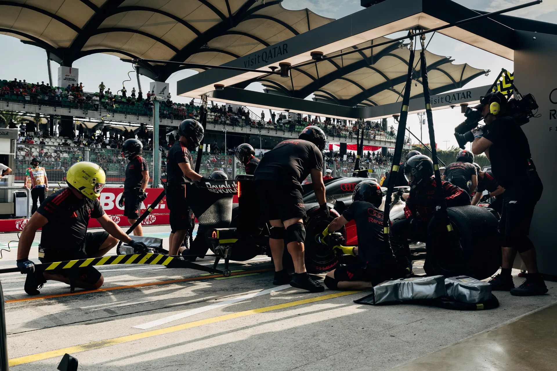 Audi Revolut F1® Team pit crew working around the Audi R26