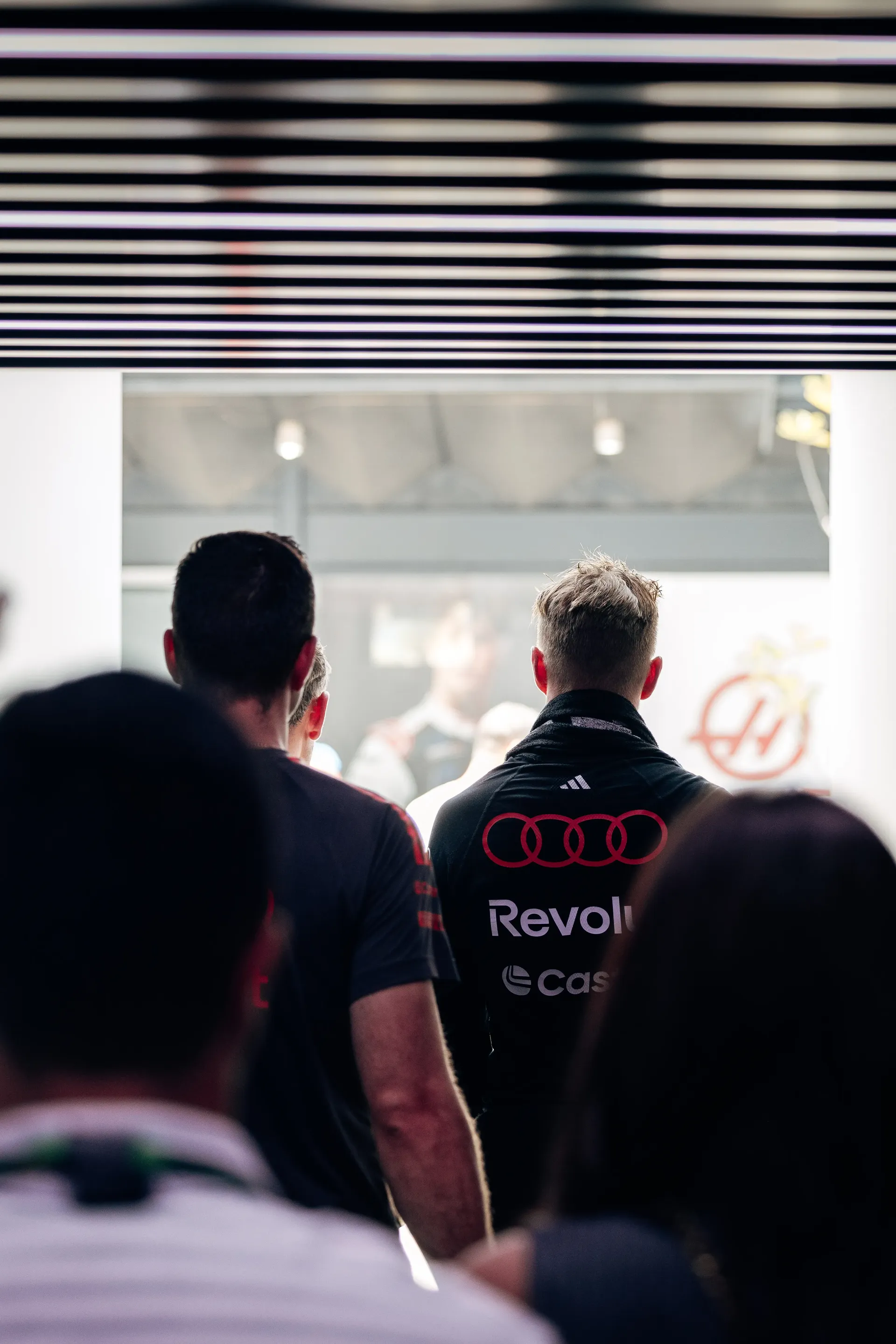 Nico Hulkenberg driver at Audi Revolut F1® Team leaves the garage with crew members