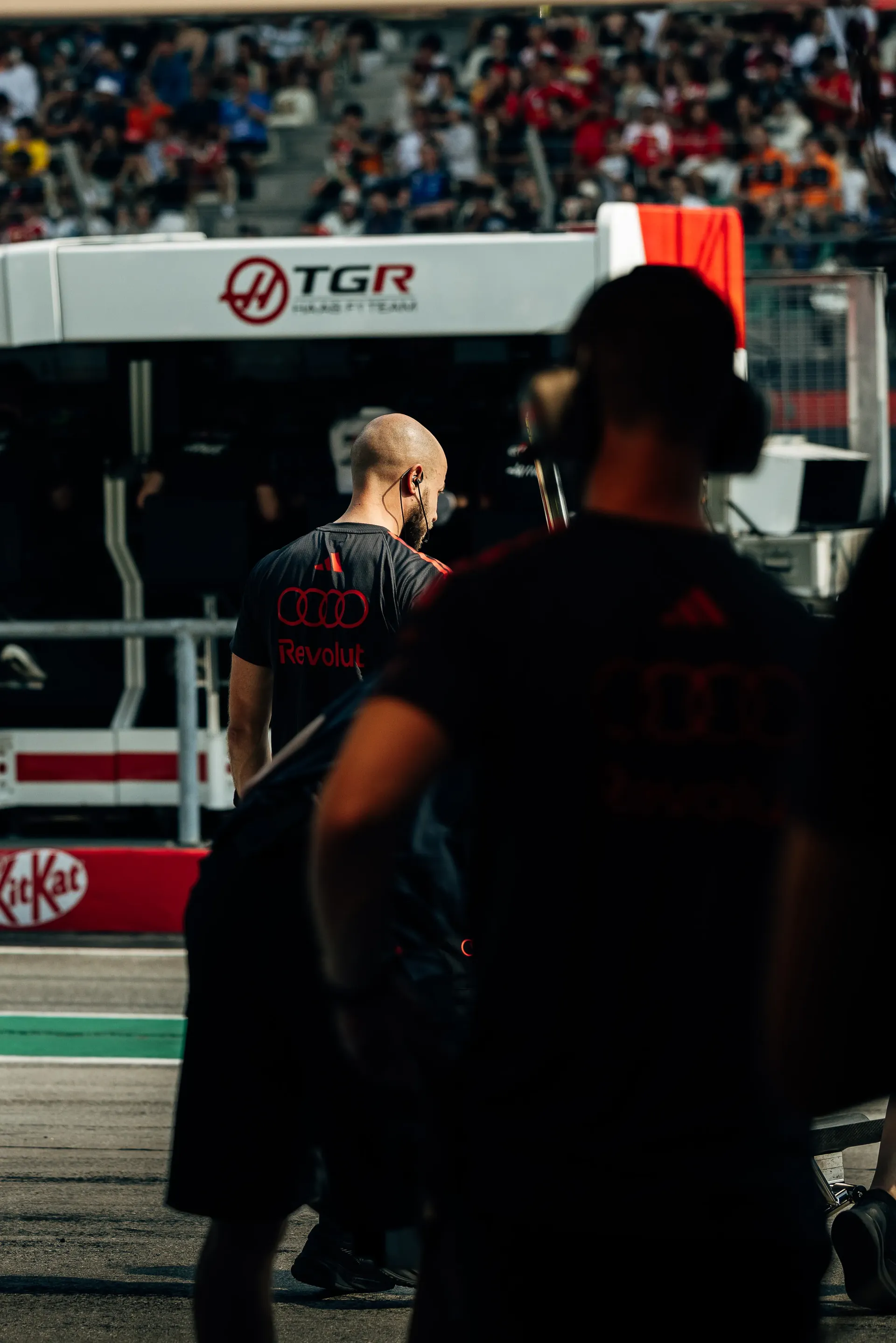 Close up of Audi Revolut F1® Team team mechanic in front of the garage
