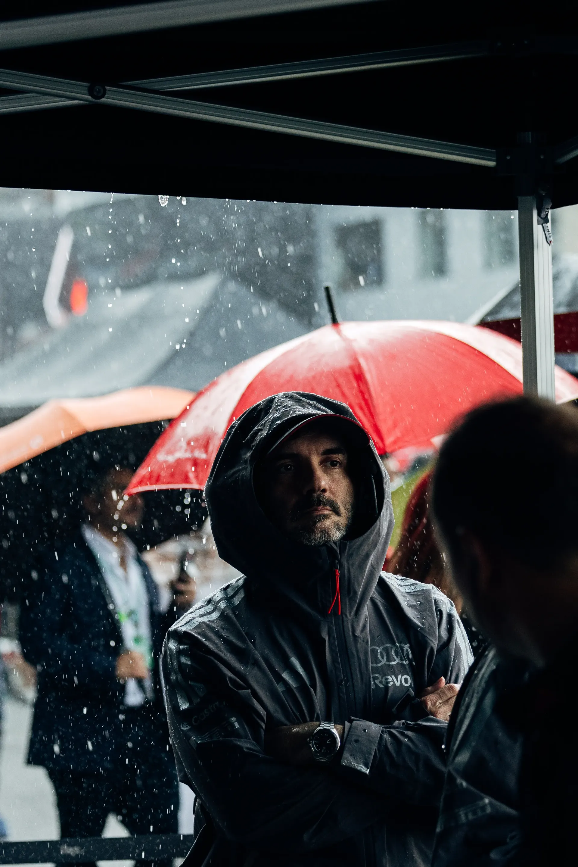 Audi Revolut F1® Team team members under umbrellas in the rain