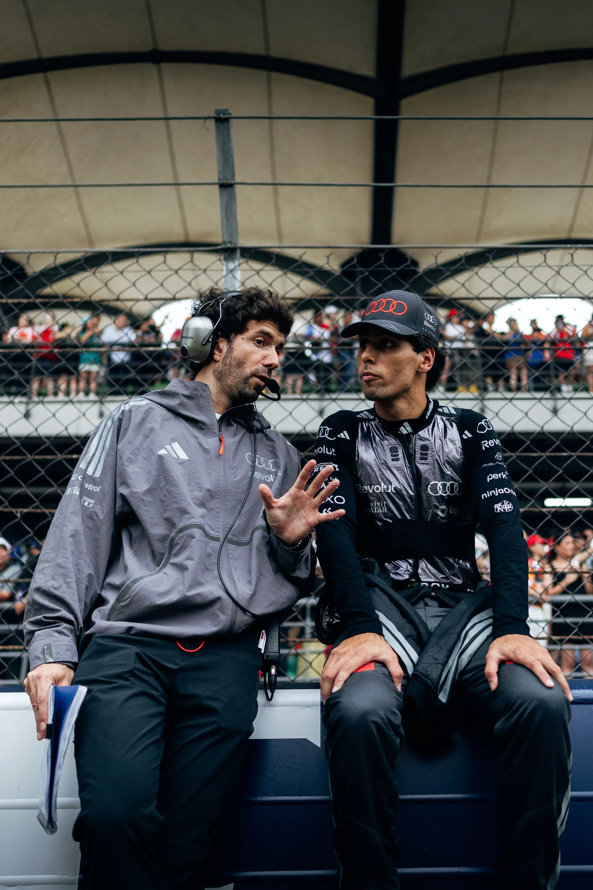 Audi Revolut F1® Team driver Gabriel Bortoleto speaking with a team member