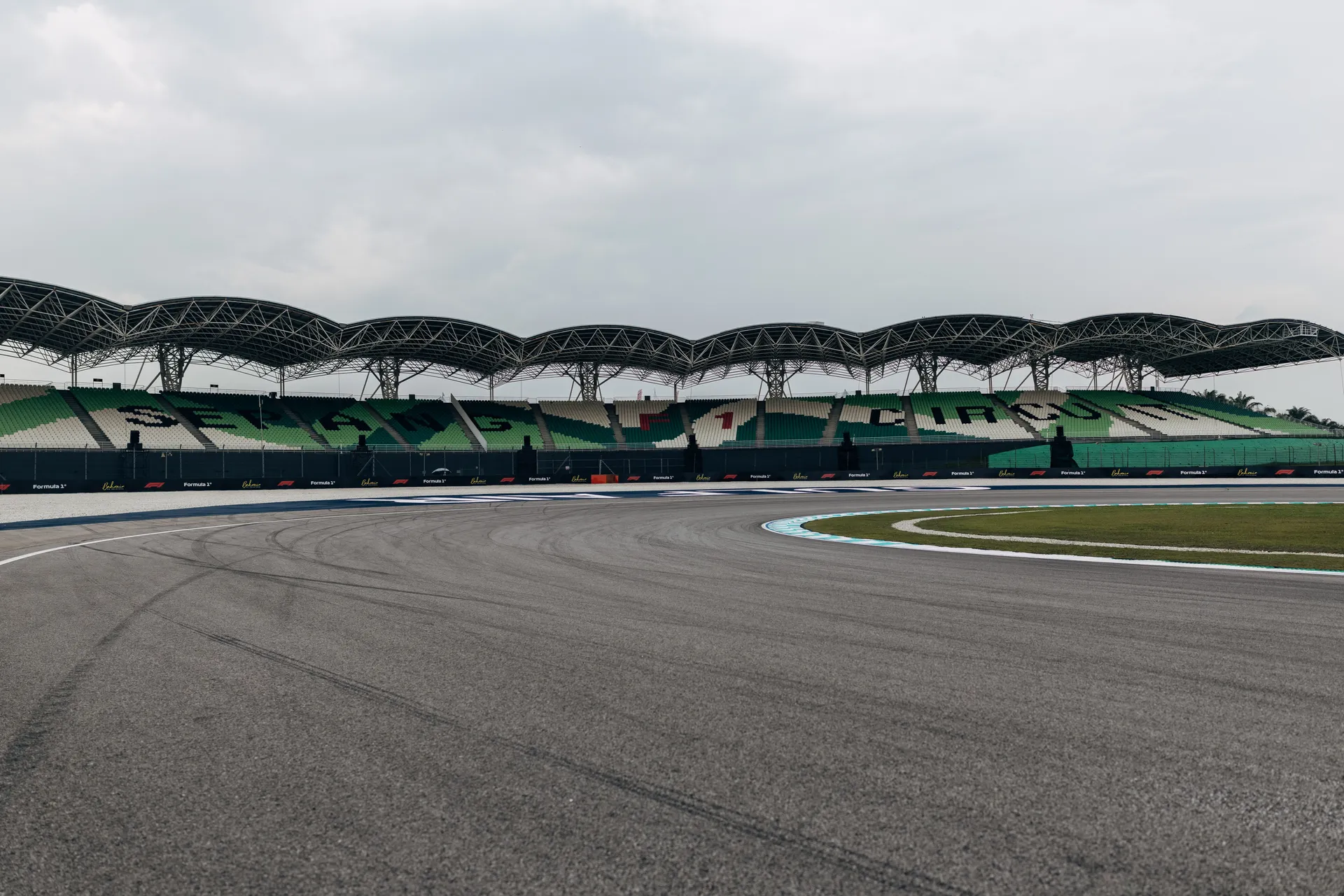 Bahrain International Circuit track section with grandstands and cloudy skies