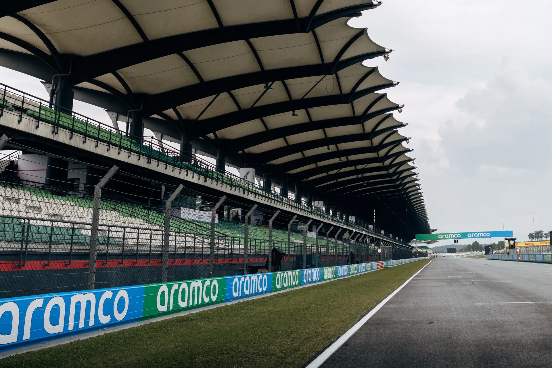 Bahrain International Circuit straight alongside covered grandstands and pit wall