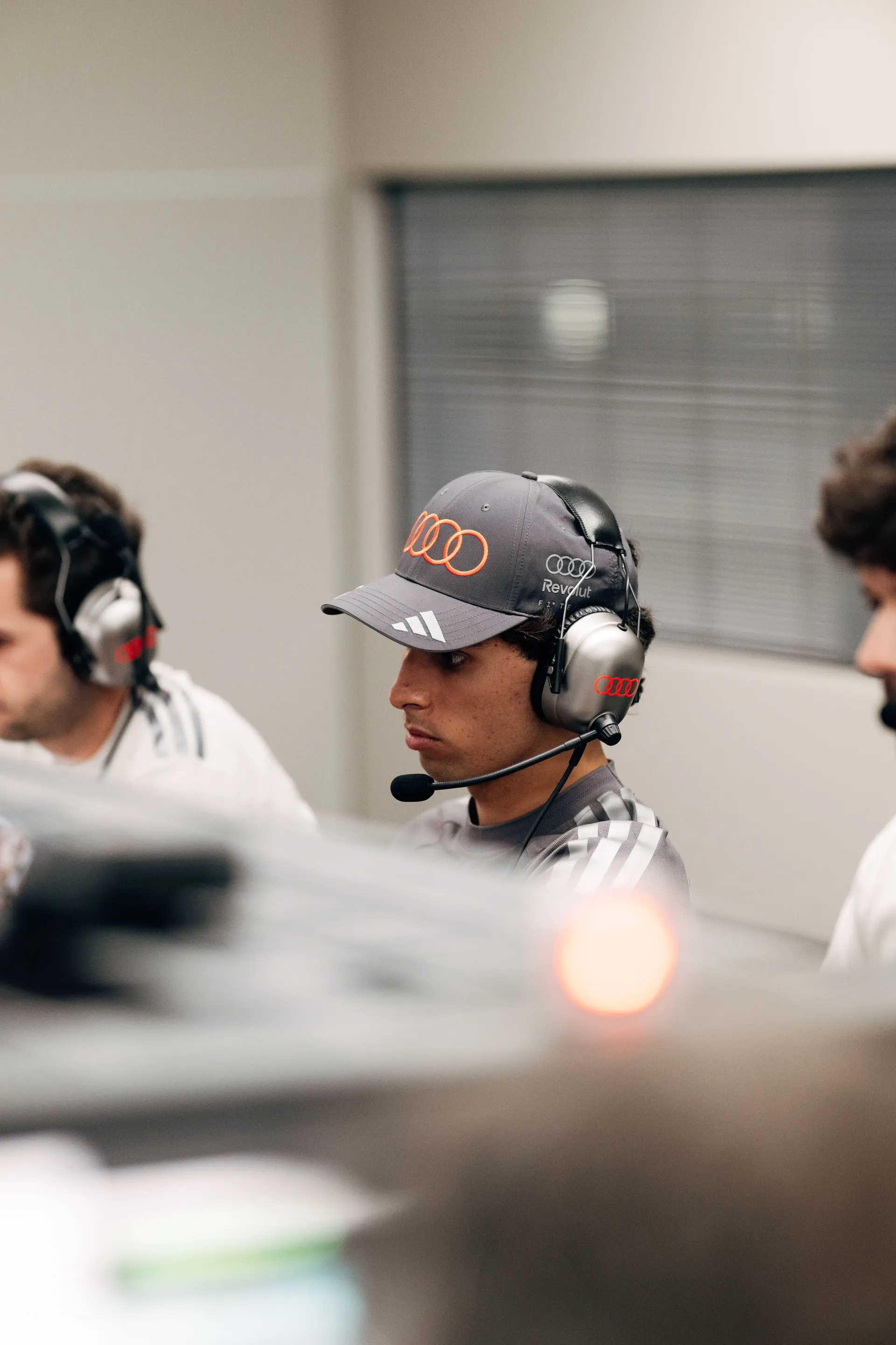 Gabriel Bortoleto driver at the Audi Revolut F1® Team inside the garage wearing headphones at the Barcelona Catalunya Grand Prix 2026