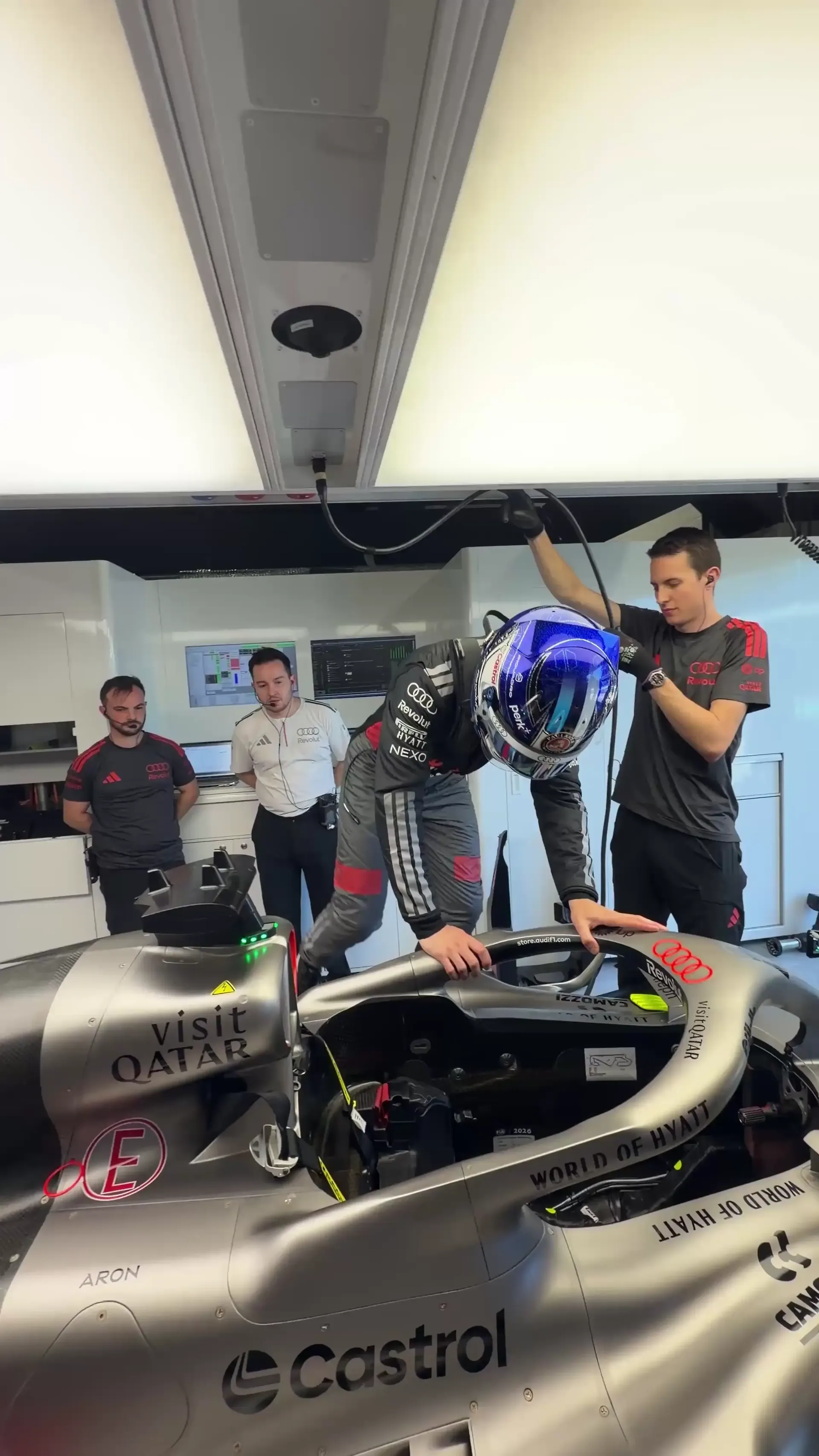 Paul Aron jumps in the R26 getting ready for FP1 for the Audi Revolut F1® Team