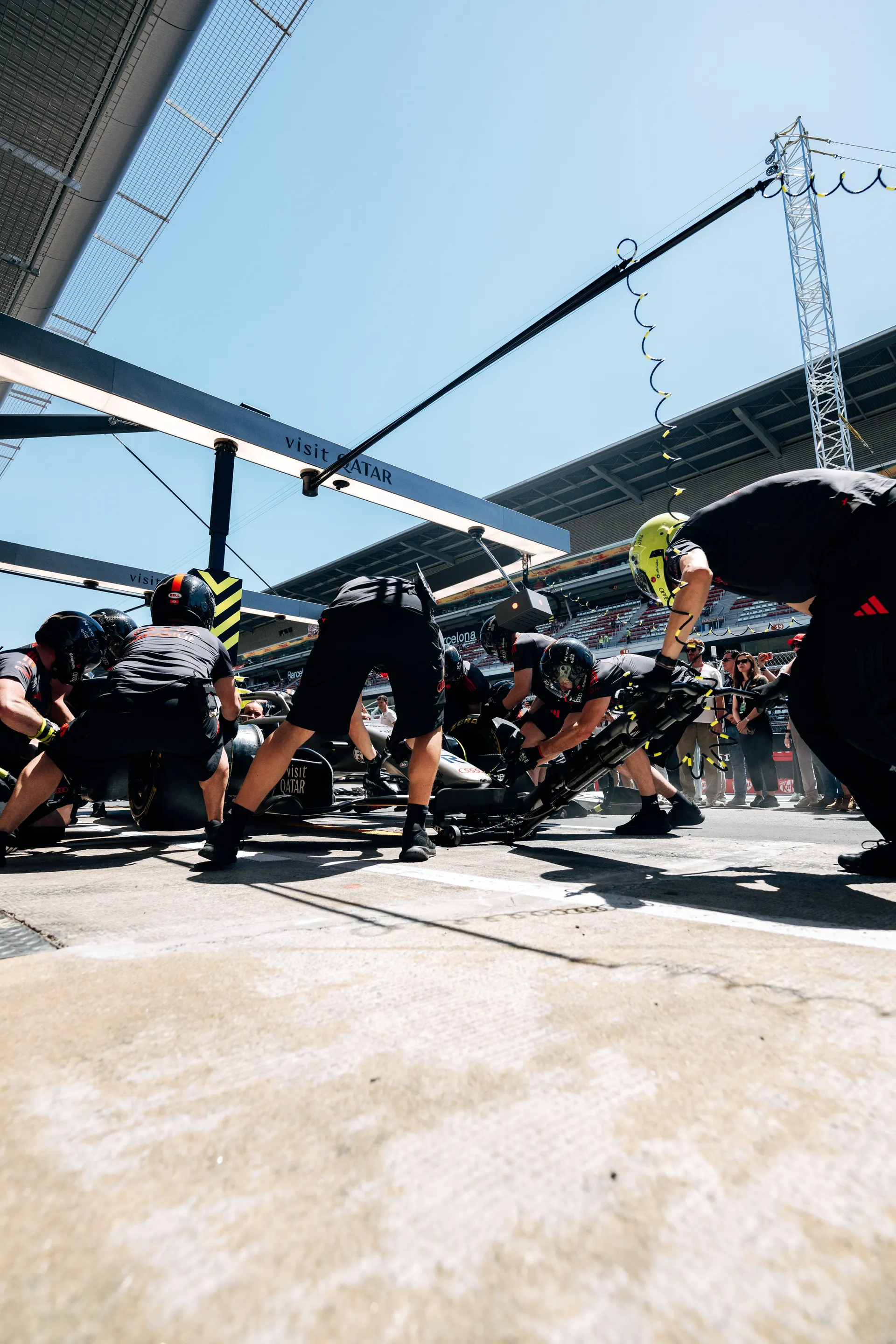 Audi Revolut F1® Team pit crew performing a pit stop during practice at Circuit de Barcelona-Catalunya