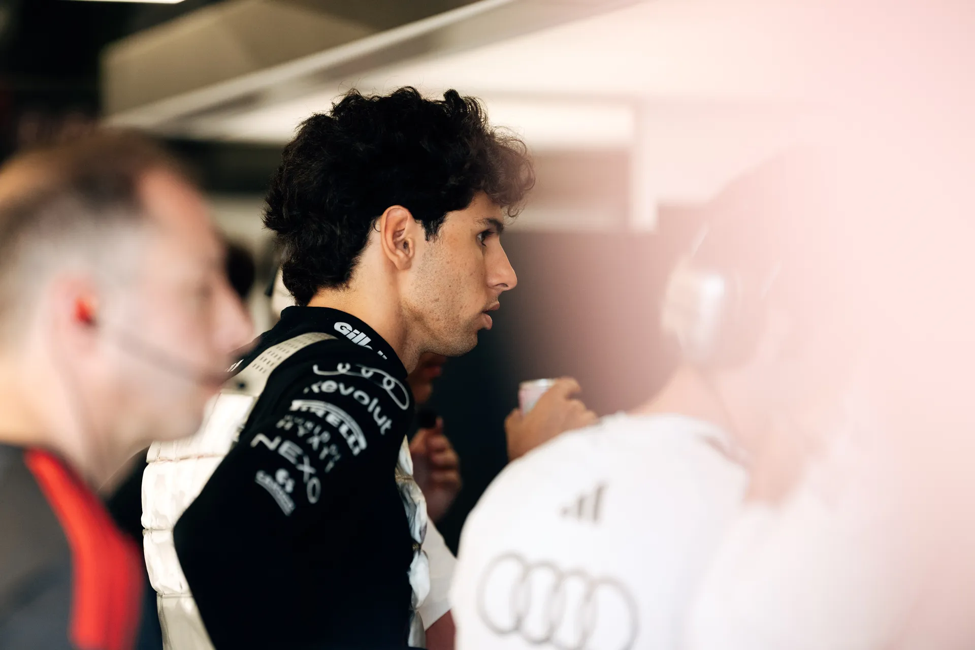 Gabriel Bortoleto focused inside the garage during a technical discussion with team members