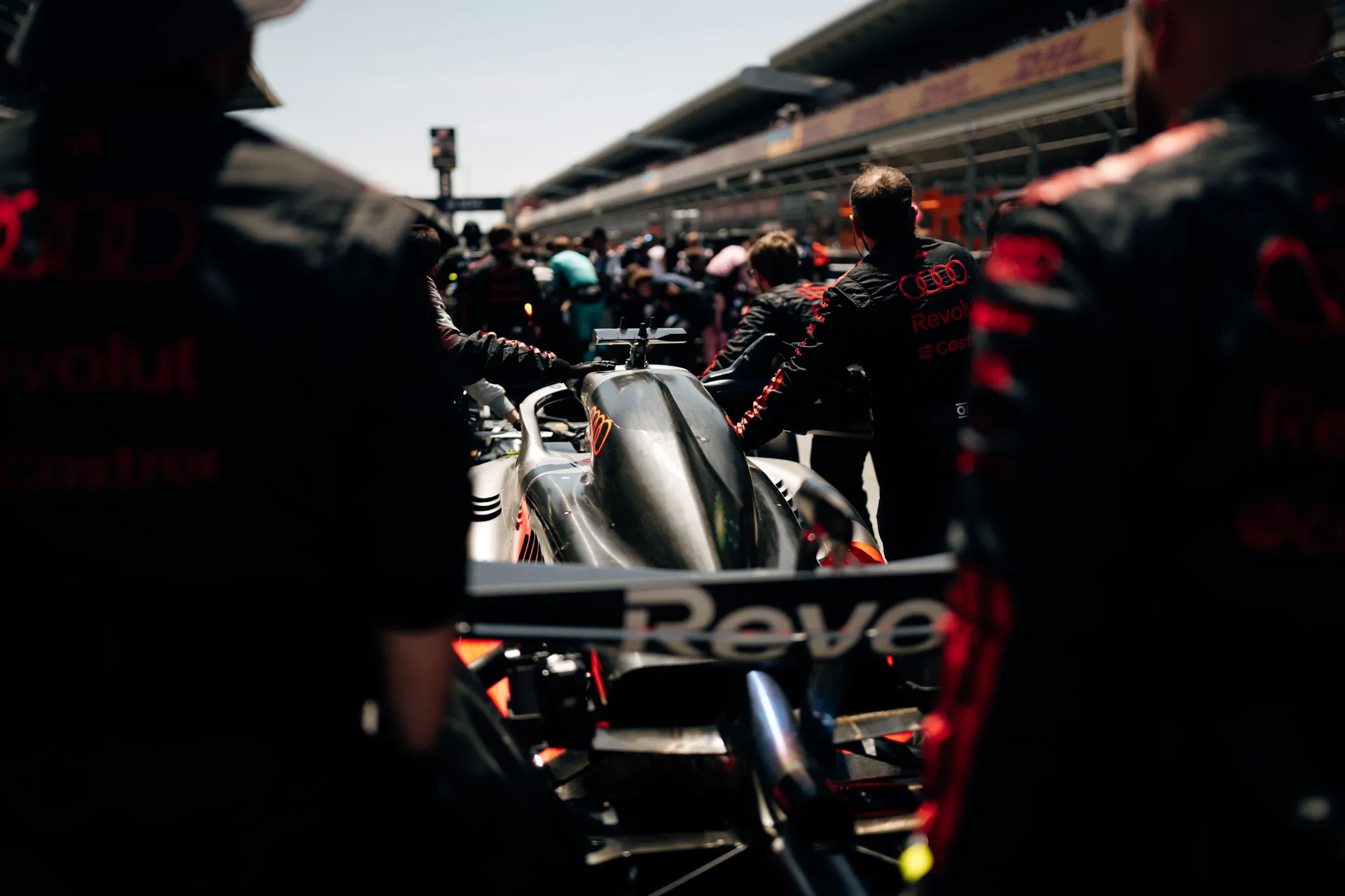 Audi R26 being pushed into position on the Barcelona grid by Audi Revolut F1® Team crew during pre-race preparations.
