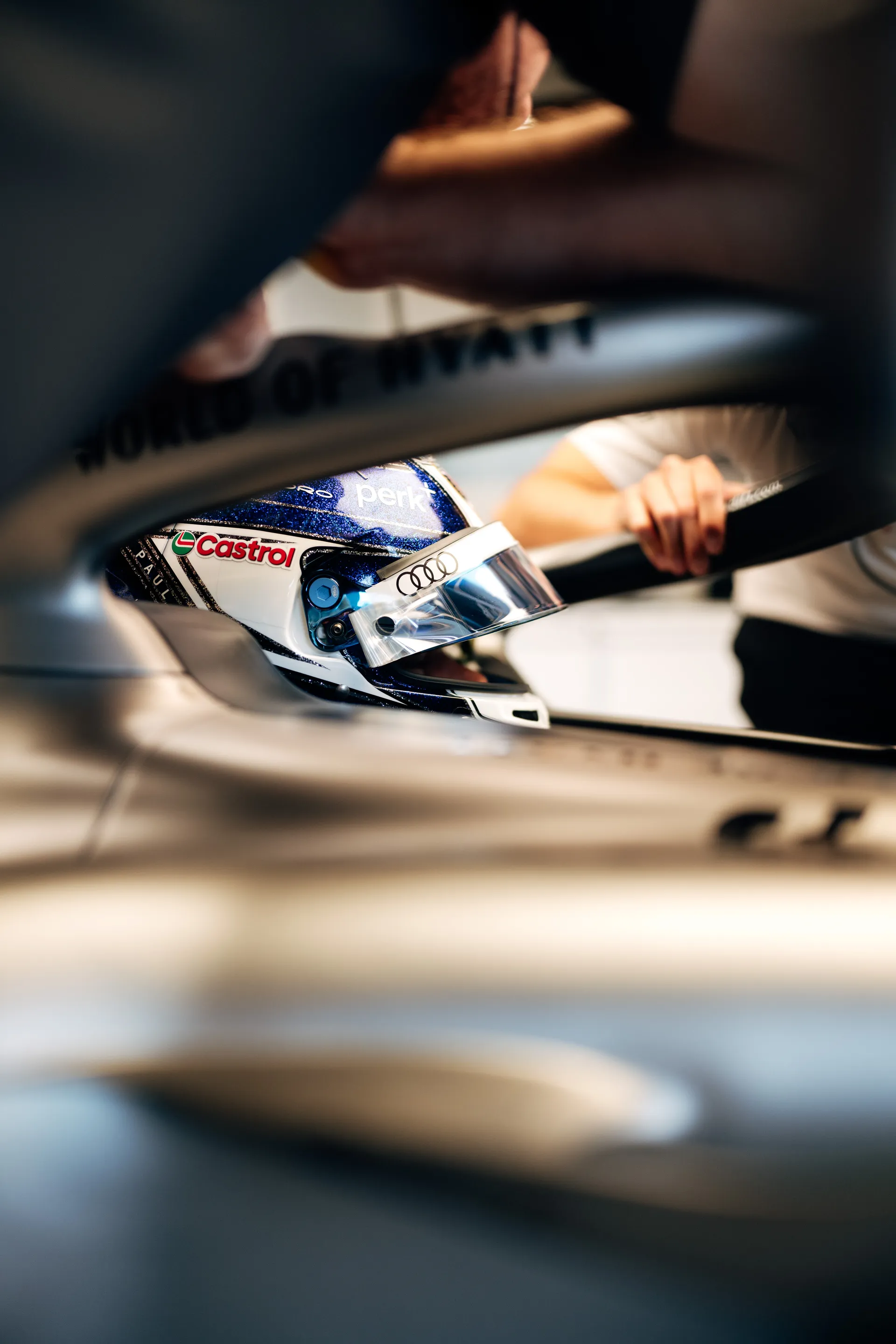 Tight cockpit shot of Paul Aron wearing a blue helmet.