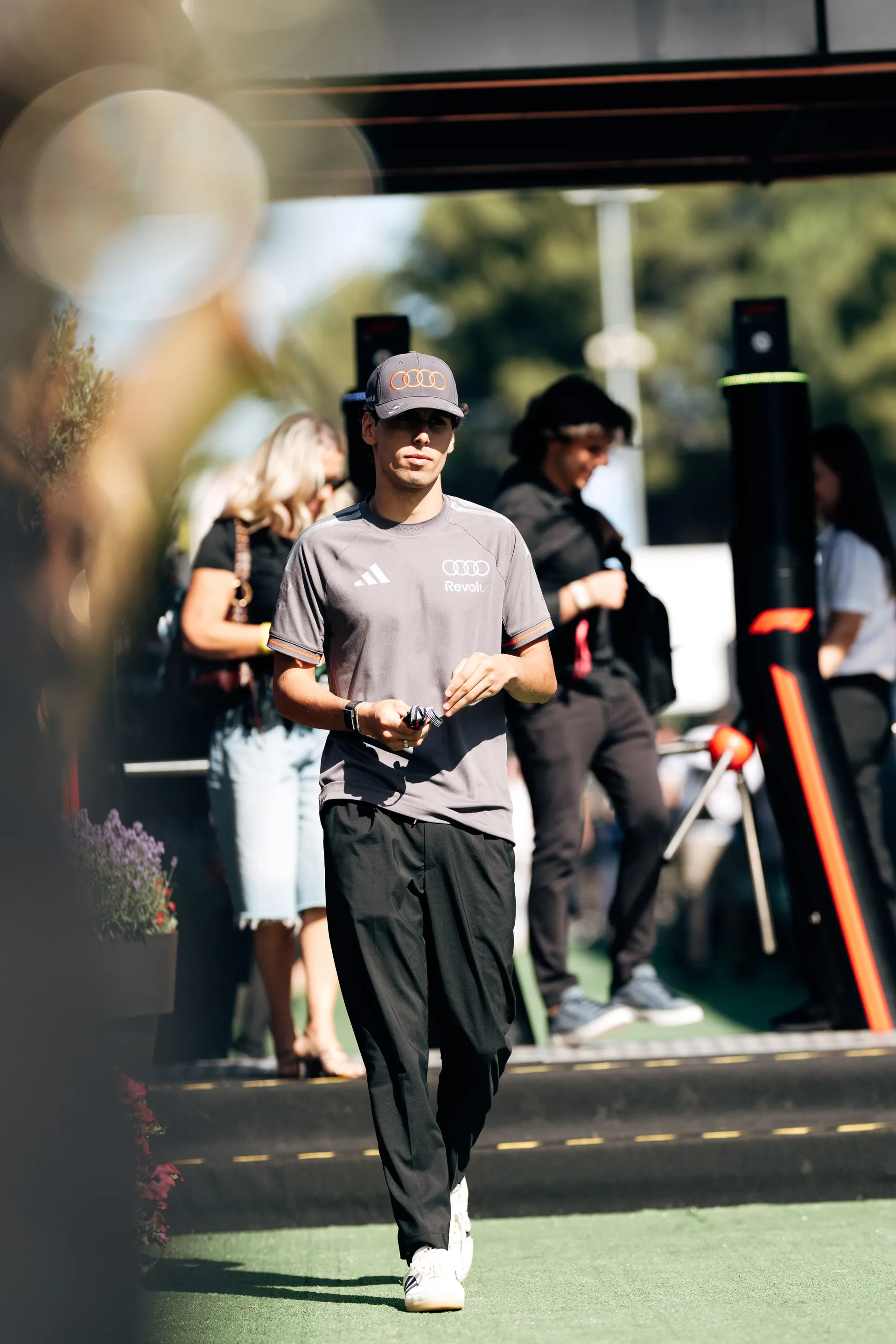 Gabriel Bortoleto arriving in the paddock wearing Audi Revolut F1® Team kit and cap
