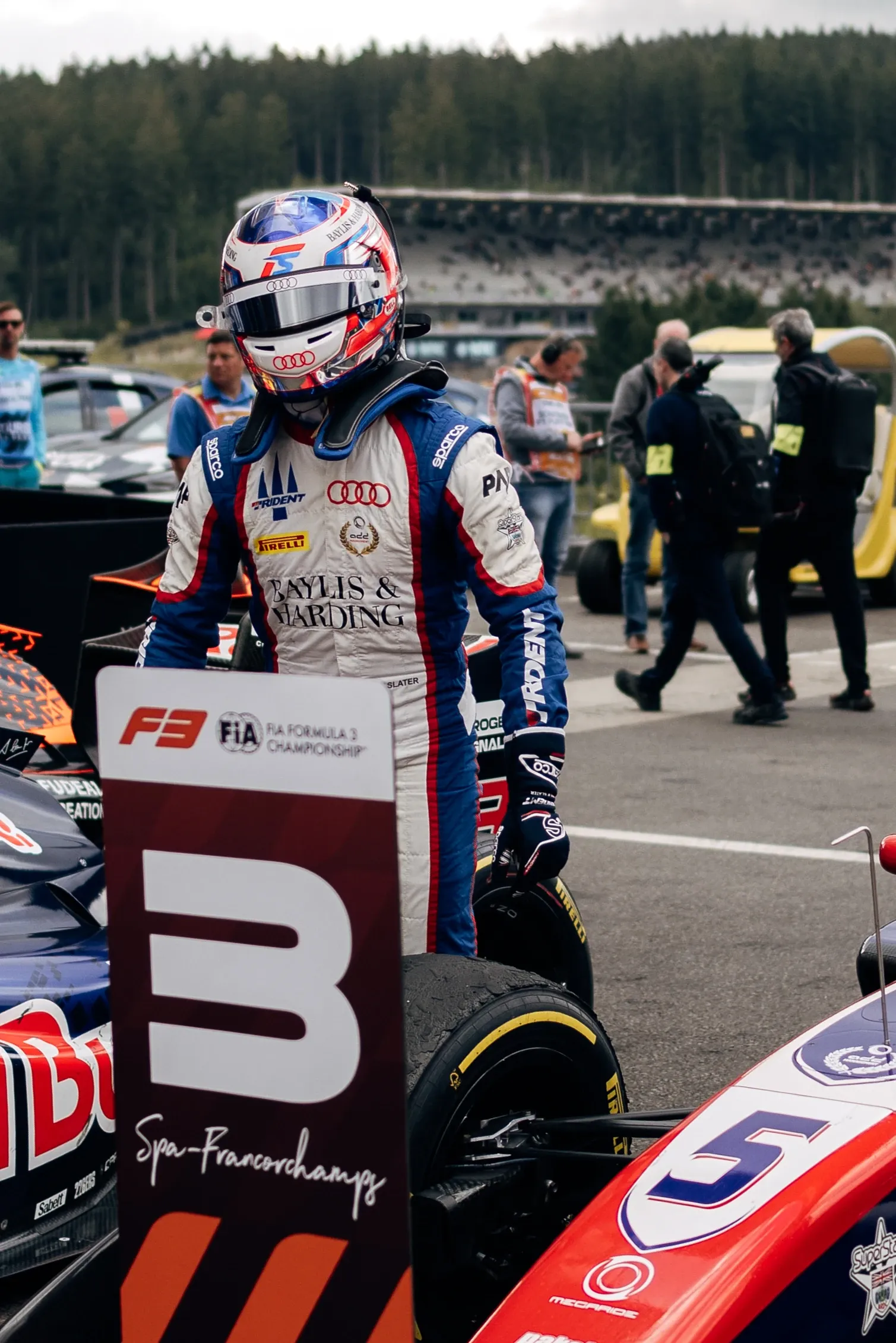 Freddie Slater stands beside his Formula 3 car on the grid at Spa Francorchamps next to a P3 position board after the race