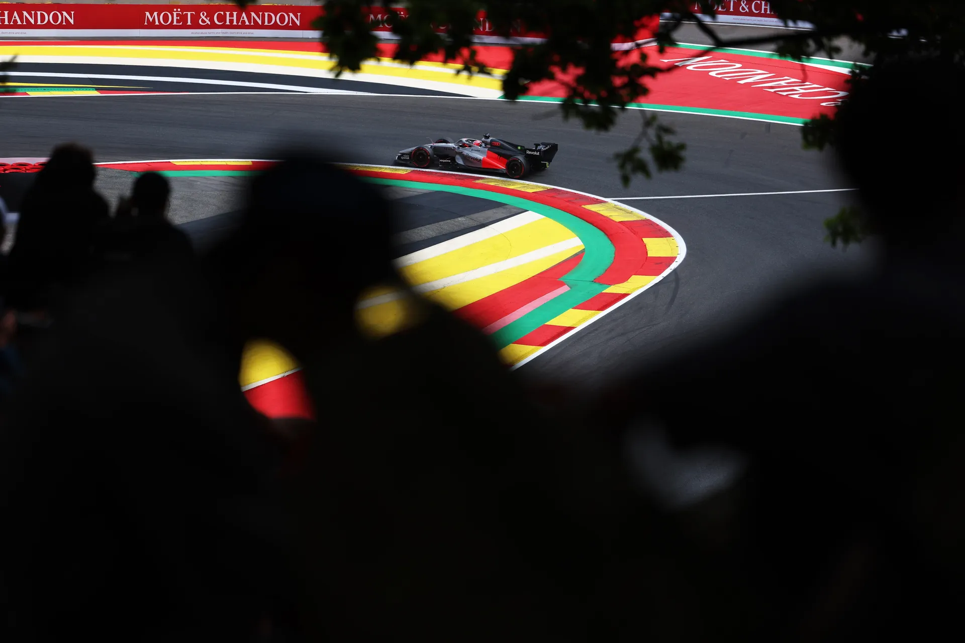 Audi R26 of Audi Revolut F1® Team mid corner with blurred crowd in the foreground at Spa
