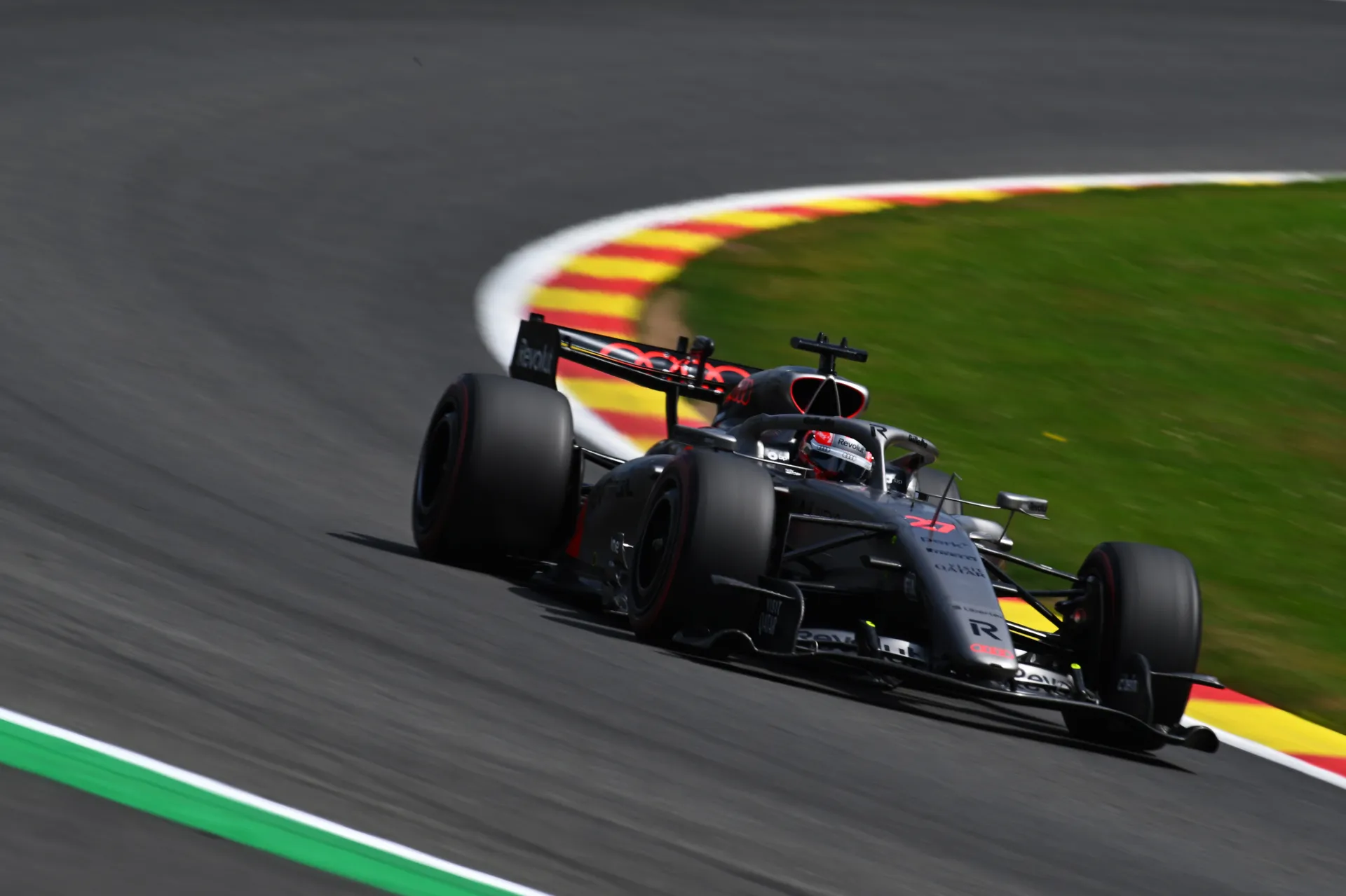 Close up of Audi R26 of Audi Revolut F1® Team cornering with focus on car body and track surface