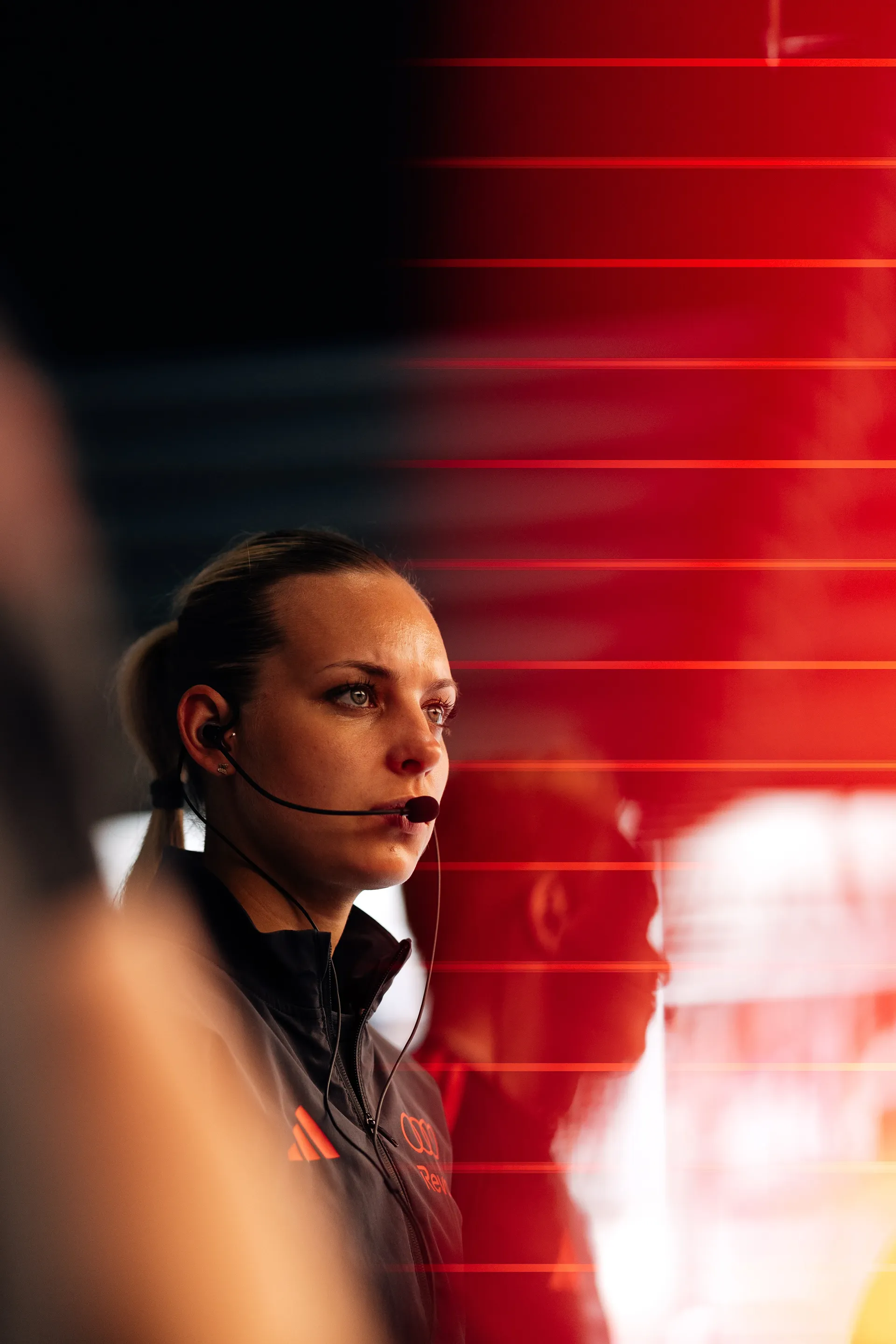 Audi Revolut F1® Team engineer wearing headset focuses on live data inside the garage during qualifying session