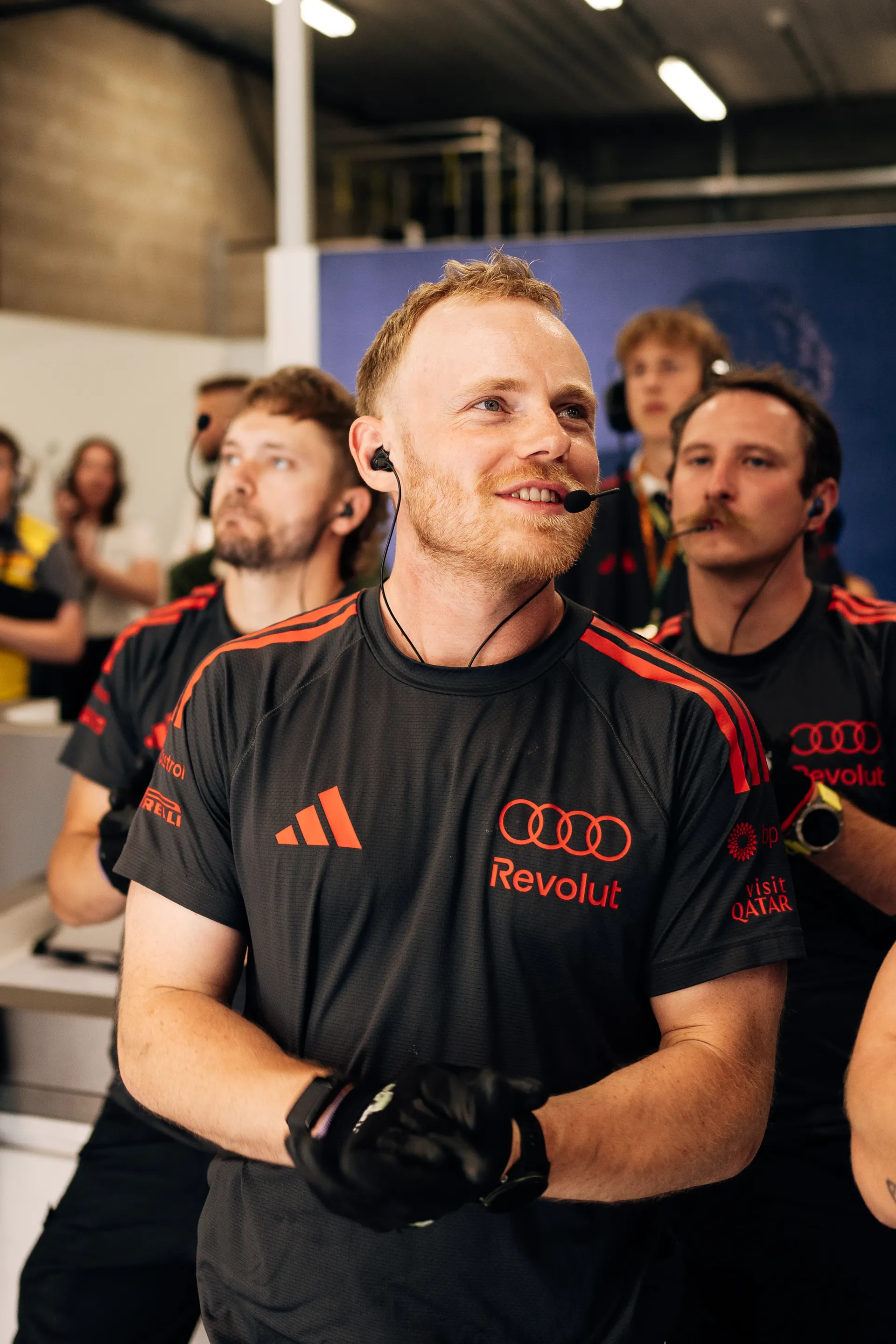 Audi Revolut F1® Team mechanics watch the session on screens inside the garage, reacting to qualifying action