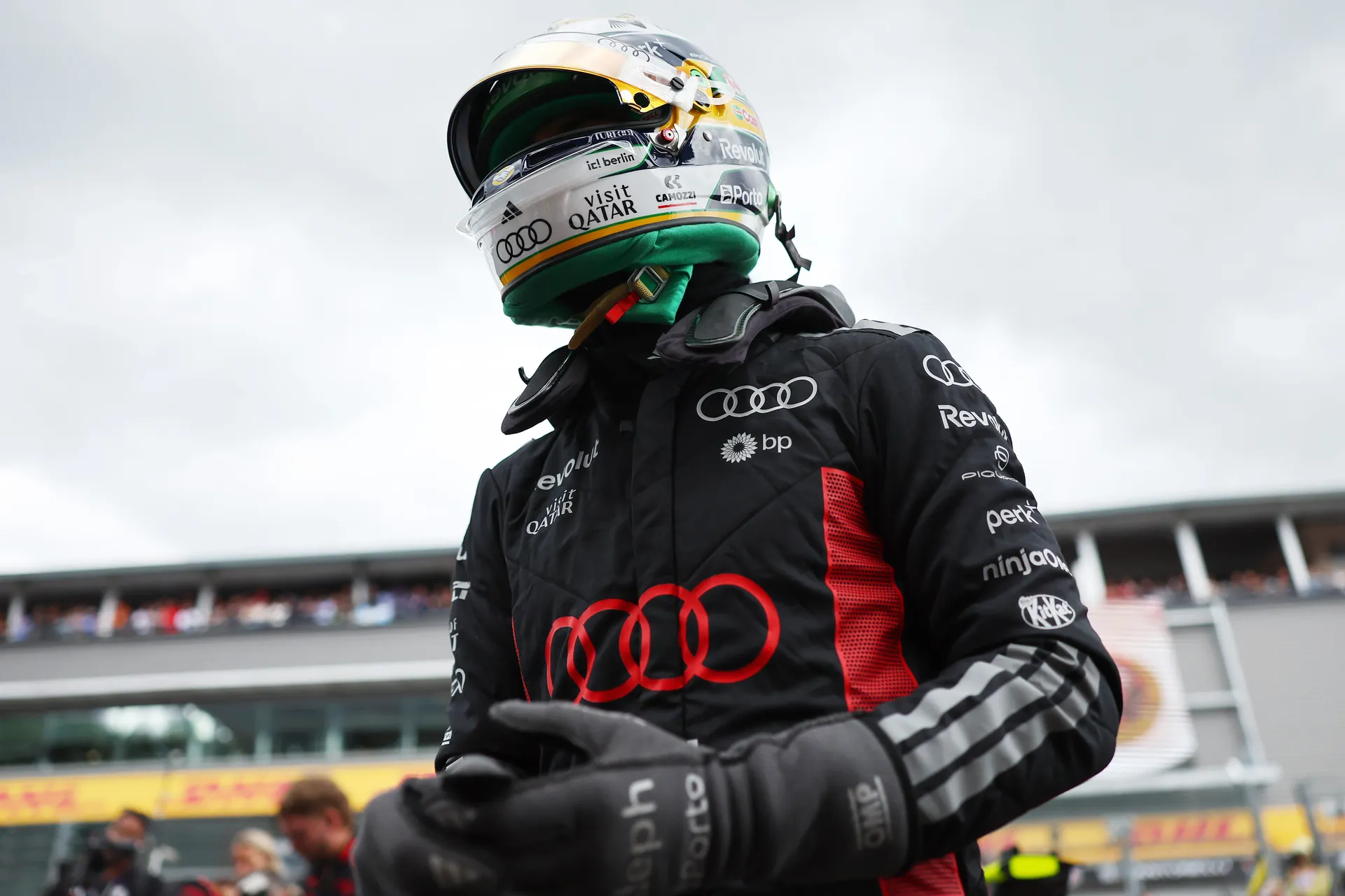Gabriel Bortoleto stands in full race gear with visor down, moments before heading to the car for Audi Revolut F1® Team.