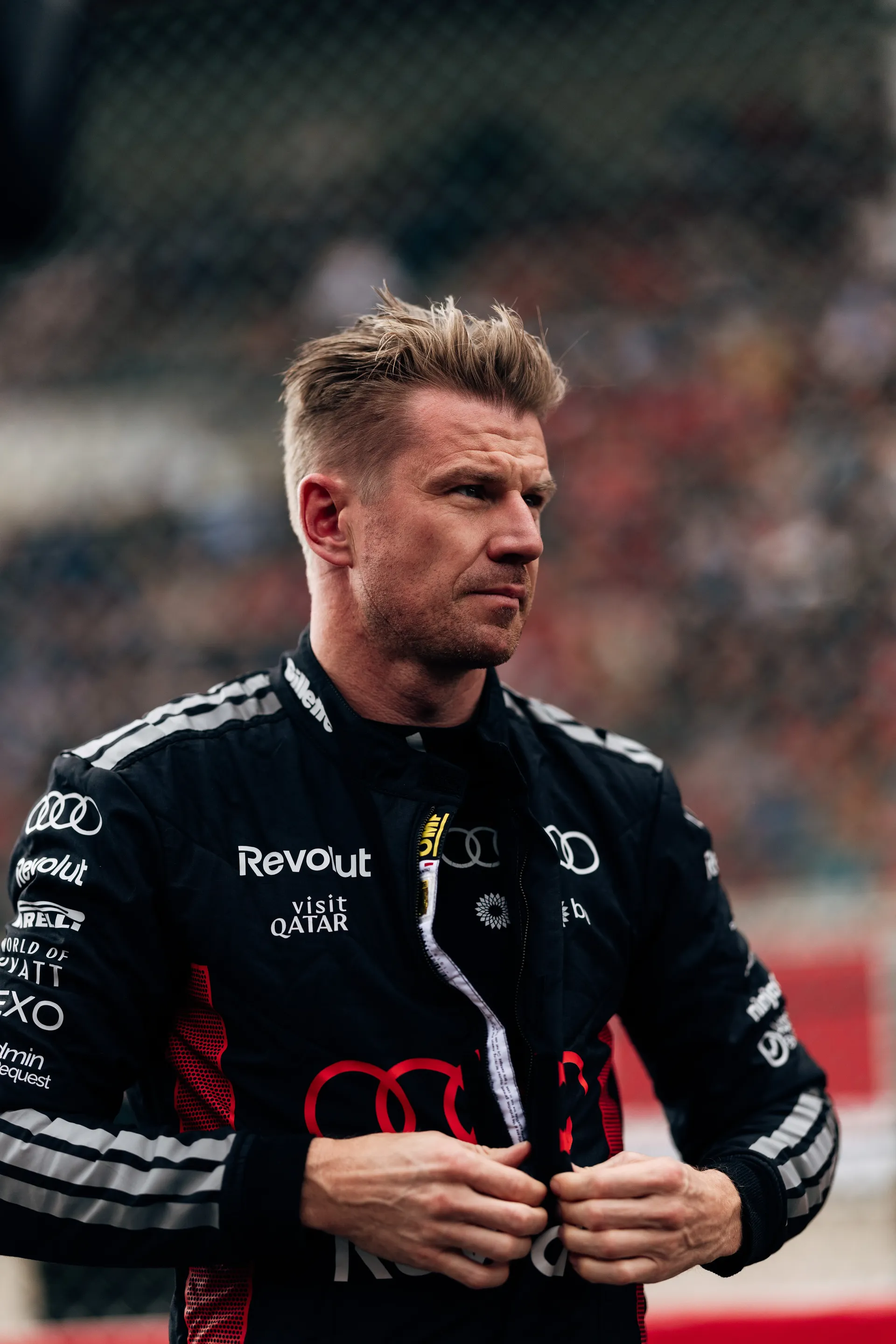 Nico Hulkenberg stands focused on the grid in Audi Revolut F1® Team race suit ahead of the session at Spa-Francorchamps.